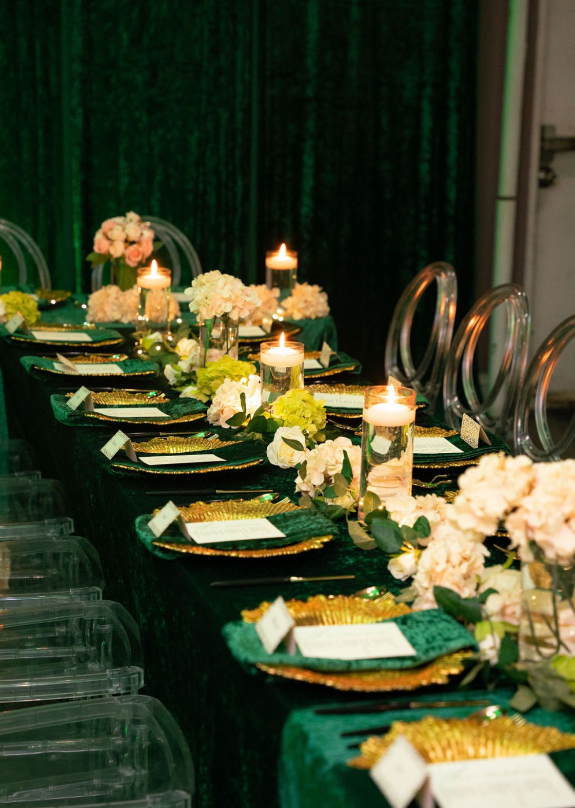 A beautifully arranged banquet table decorated with candles, flowers, and elegant tableware for a formal event or celebration.