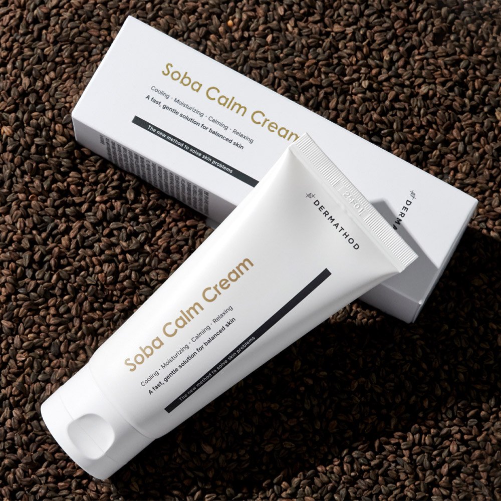 Dermathod Soba Calm Cream bottle and box laying on beans.jpg
