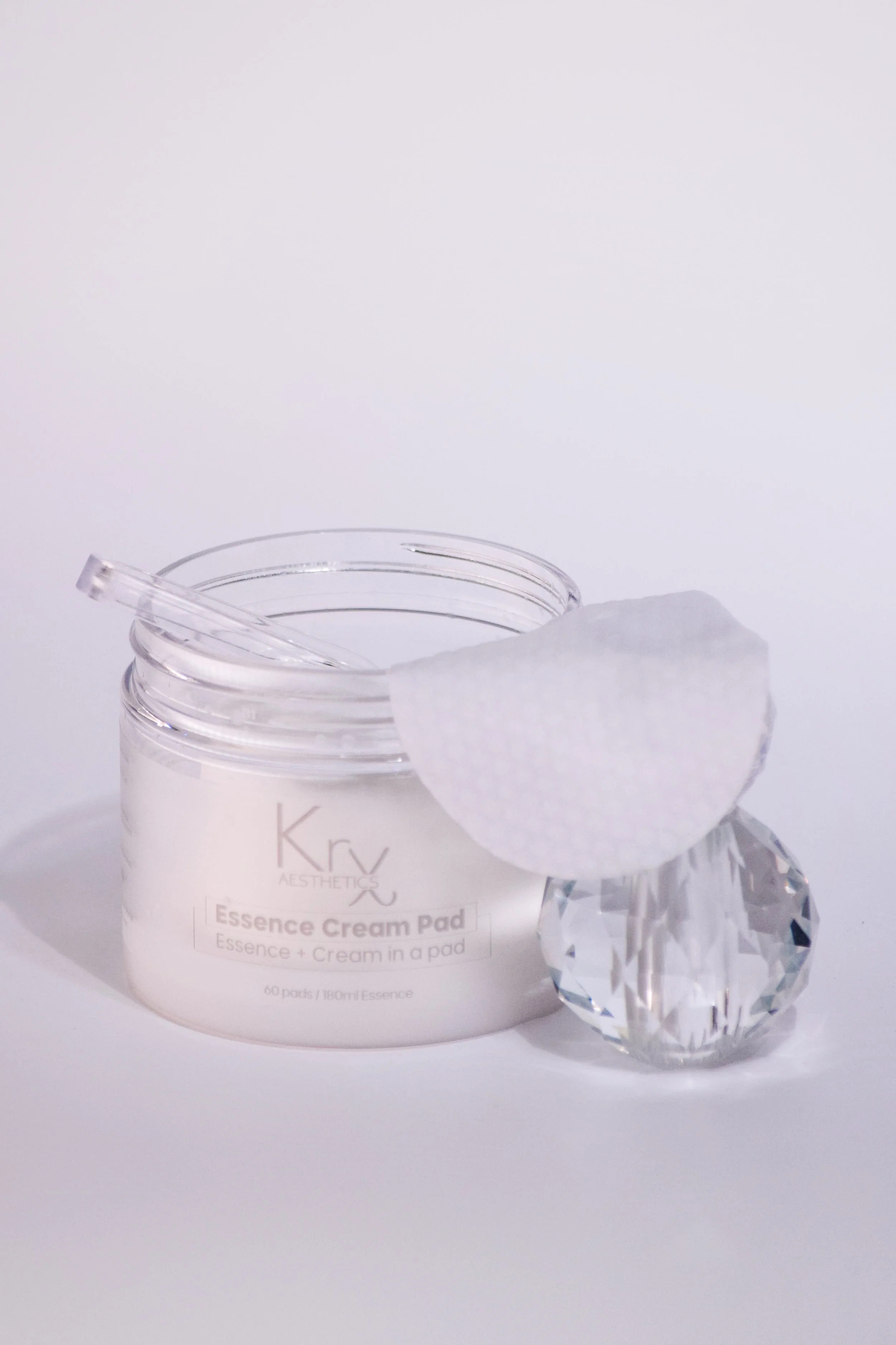 Milky essence texture of KrX Essence Cream Pads on skin