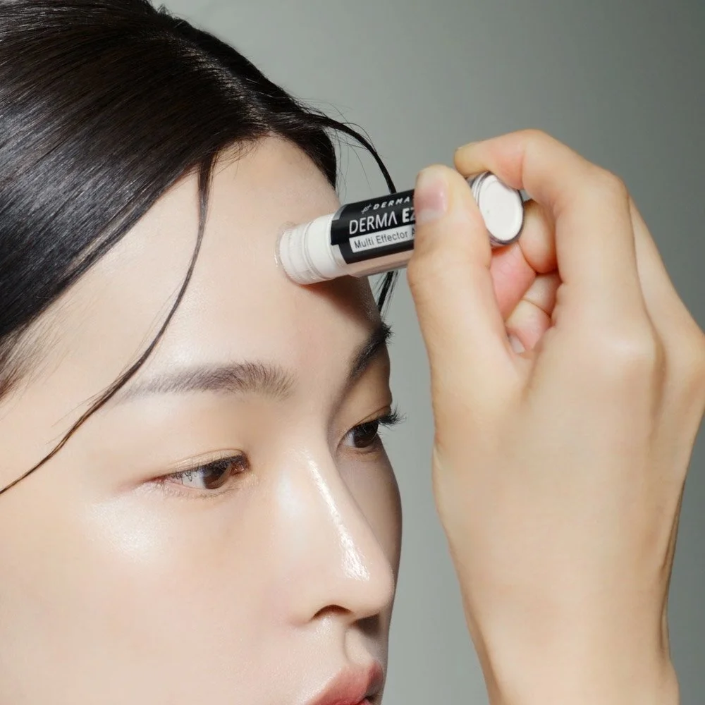 Dermathod EZ Jet Multi Set woman applying ampoule to forehead.jpg