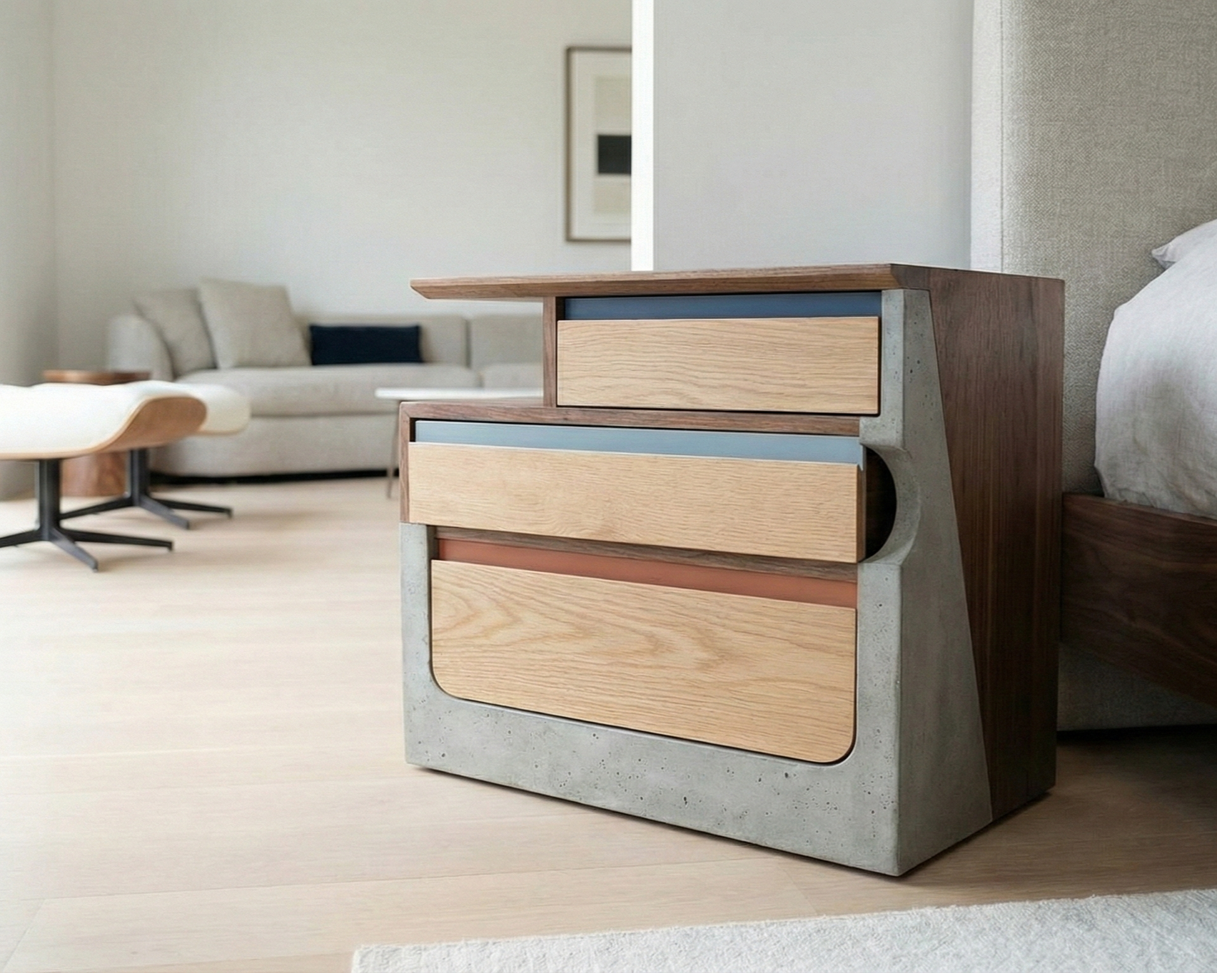 A modern nightstand with a concrete frame and wood drawers, beside a bed in a minimalistic bedroom.