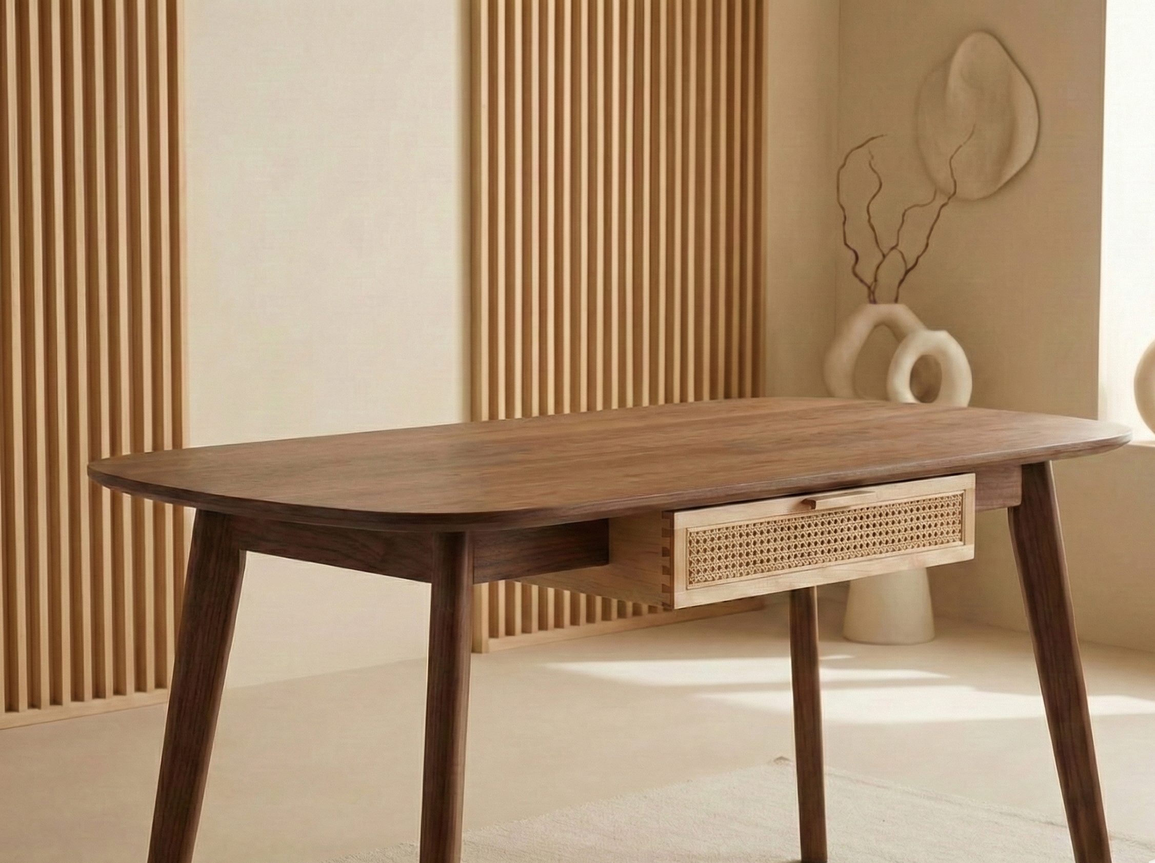 A wooden table with a drawer in a minimalist room with light-colored walls, decorative elements, and wooden paneling.