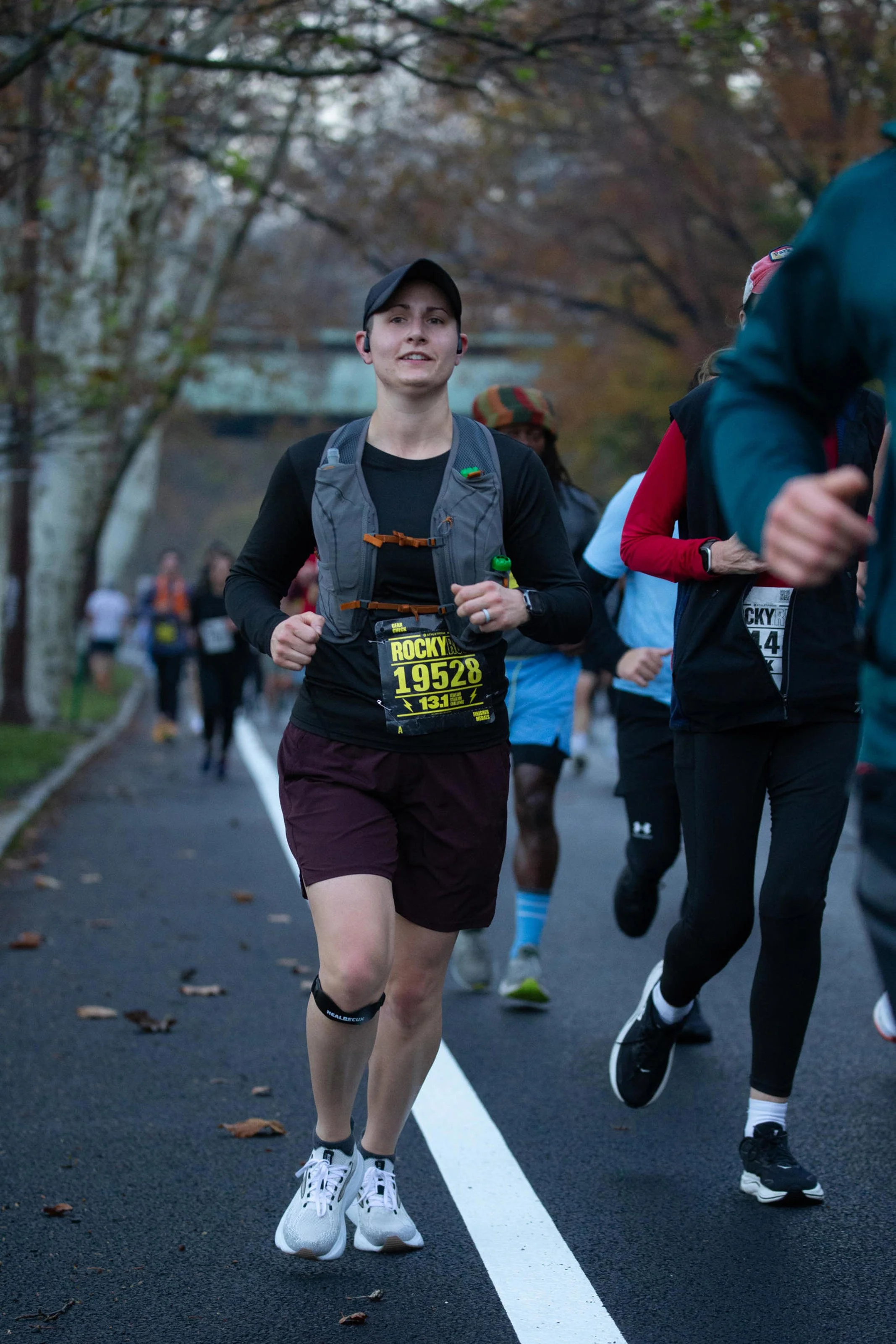 Coach Lauren competing in a road race, bringing firsthand running experience to her coaching.