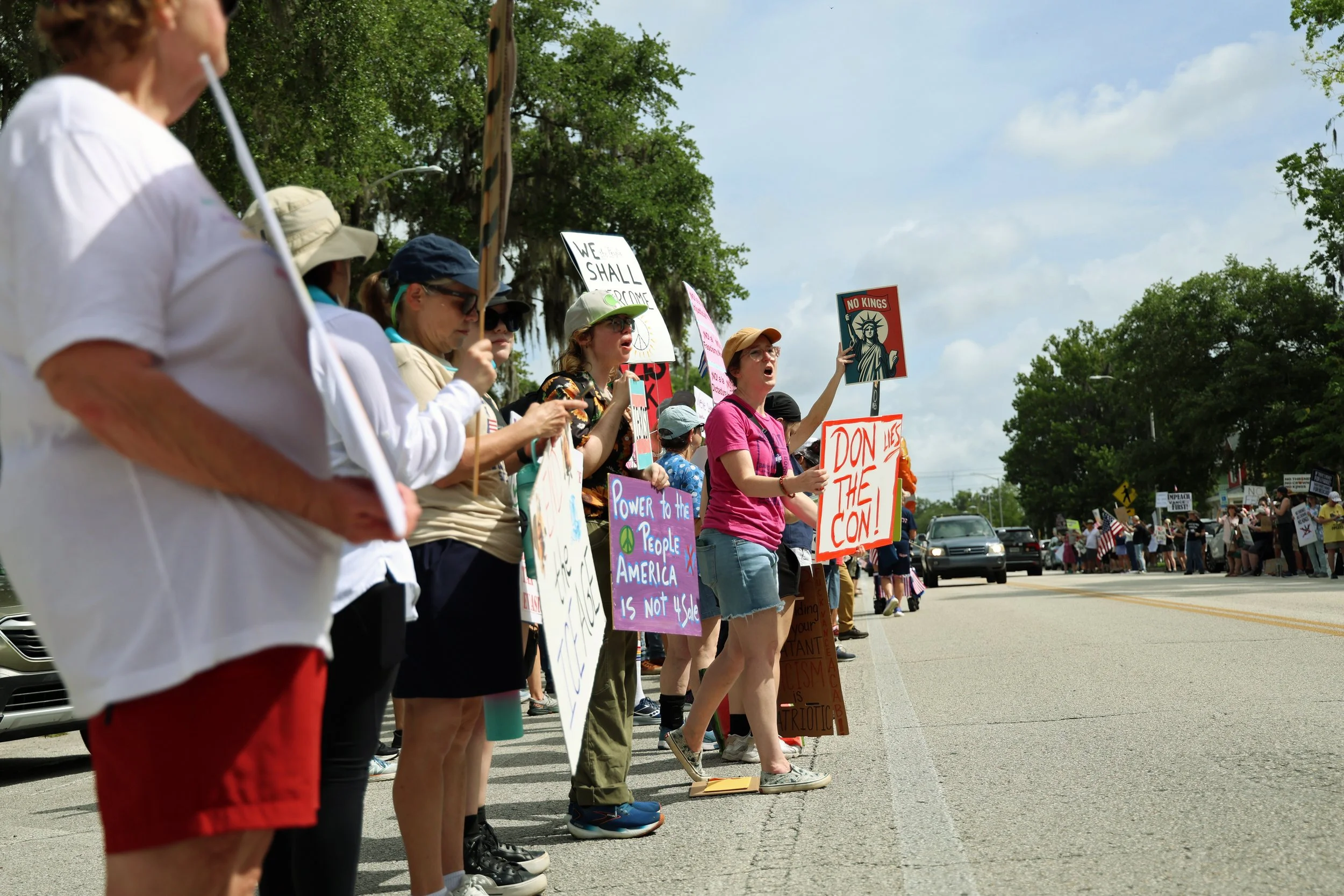 Protestors stand on both sides of Southwest Sixth Street during the "No Kings Day" protest on Saturday, June 14, 2025.