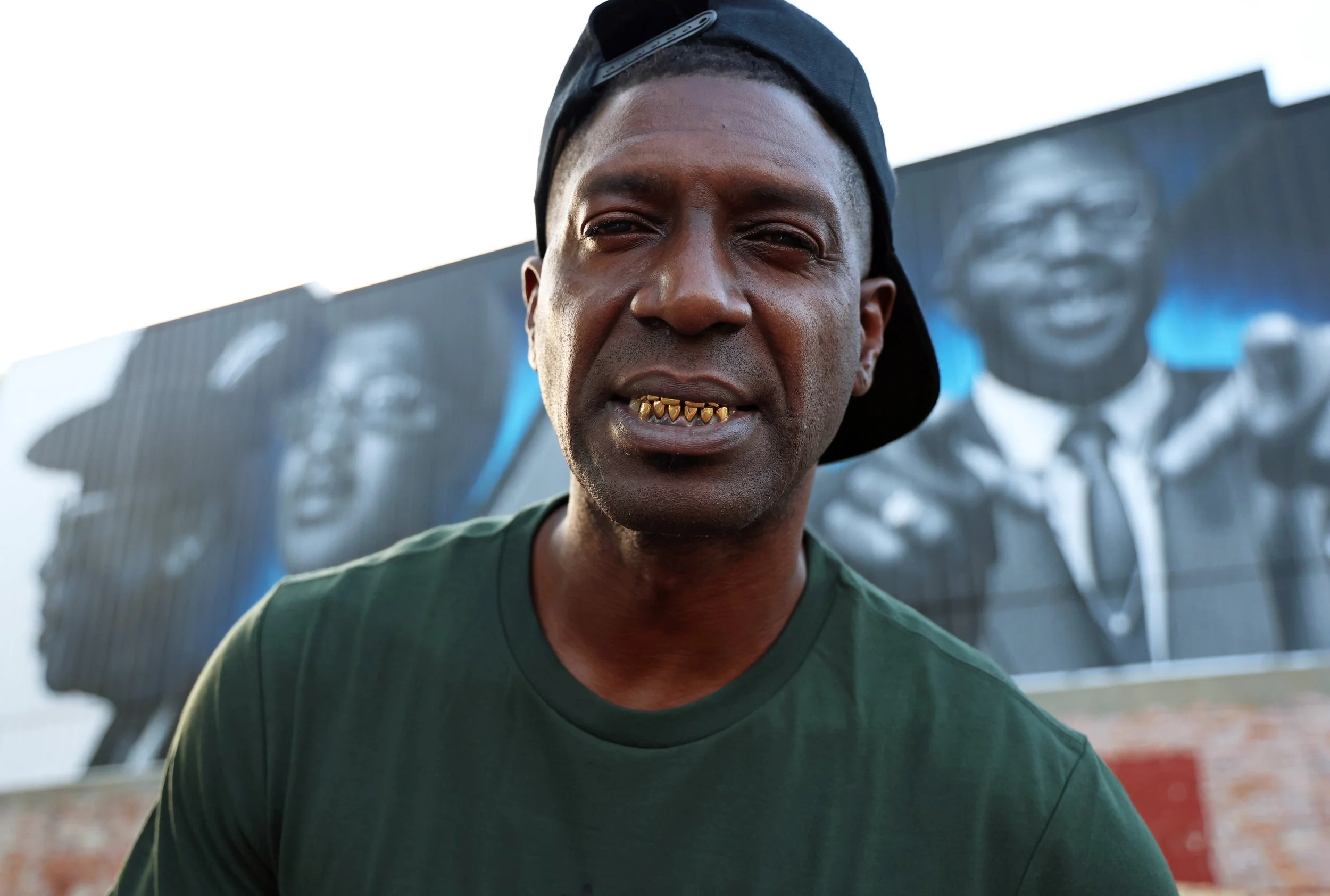 Fie Scoobie (Gerald Jones) poses in front of the Bo Diddley mural on Southwest First Avenue on Friday, July 18, 2025.
