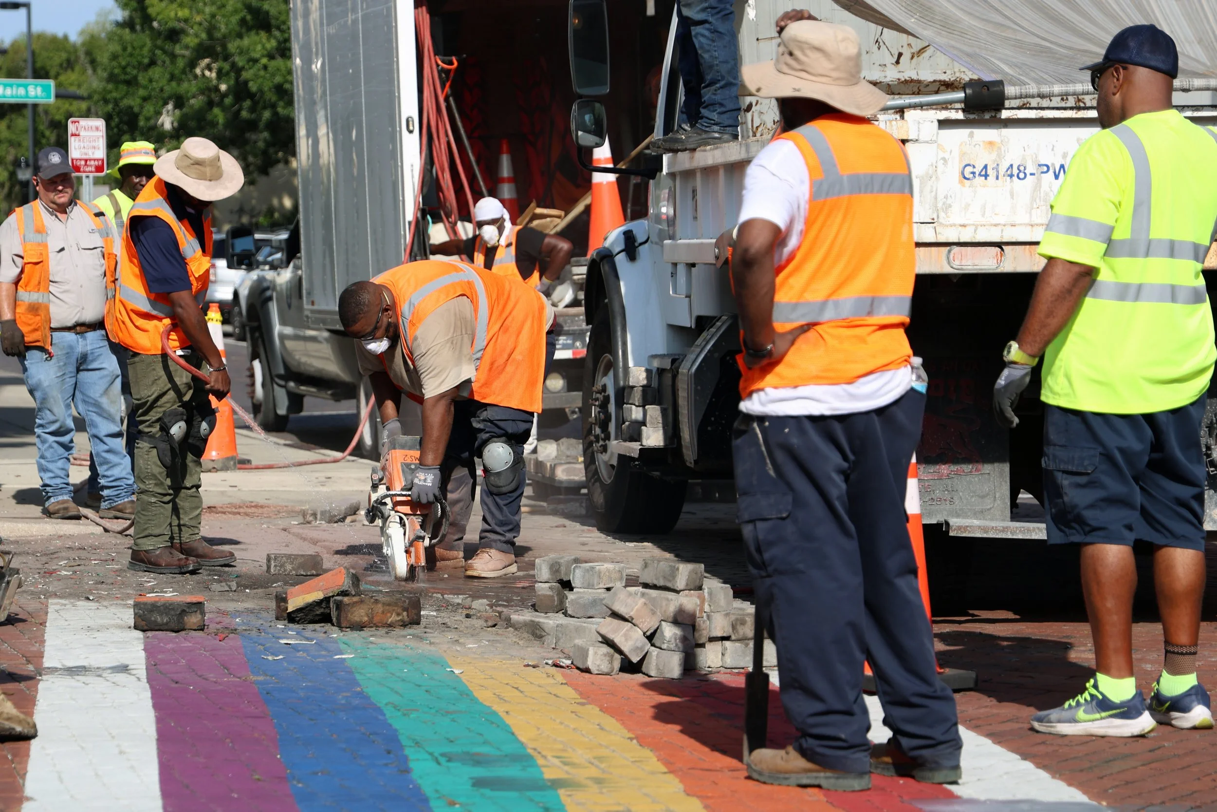 City of Gainesville Public Works employees saw, cut and pry bricks from the rainbow crosswalk near City Hall on Monday, August 25, 2025.
