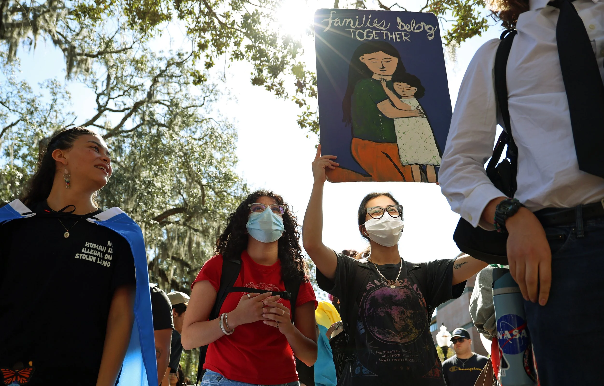 A protester holds a sign reading “Families belong together” during a Young Democratic Socialists of America protest in Turlington Plaza against the University of Florida’s decision to partner with ICE on Wednesday, Nov. 5, 2025.
