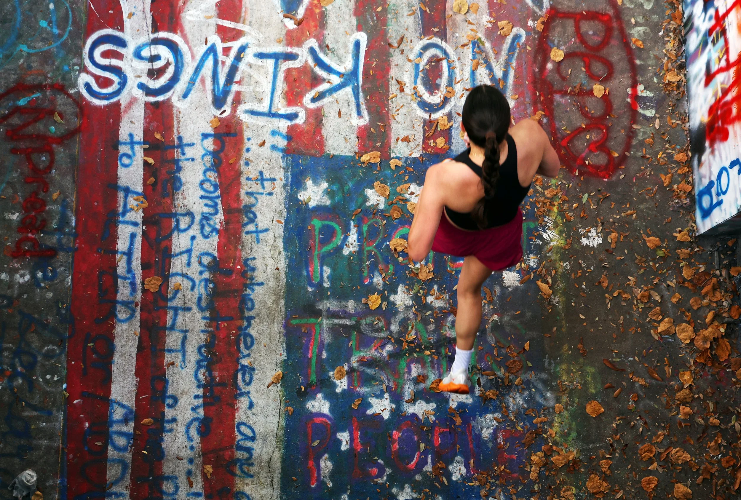 A participant runs out of the Norman Hall tunnel during the Smathers Centennial 5K on Sunday, Oct. 26, 2025, at the University of Florida in Gainesville, Fla., in celebration of Smathers Library’s centennial. (Libby Clifton/ WUFT News)