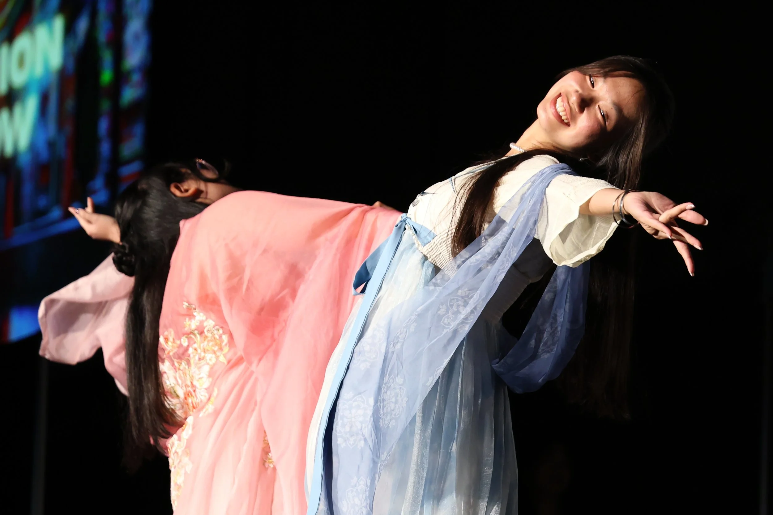 Fiona Sun leans back and extends her arm to display her hanfu, a traditional Chinese garment symbolizing cultural heritage, during the fashion show portion of the Chinese American Student Association’s annual Mid-Autumn Festival, “The Heart of Chinat