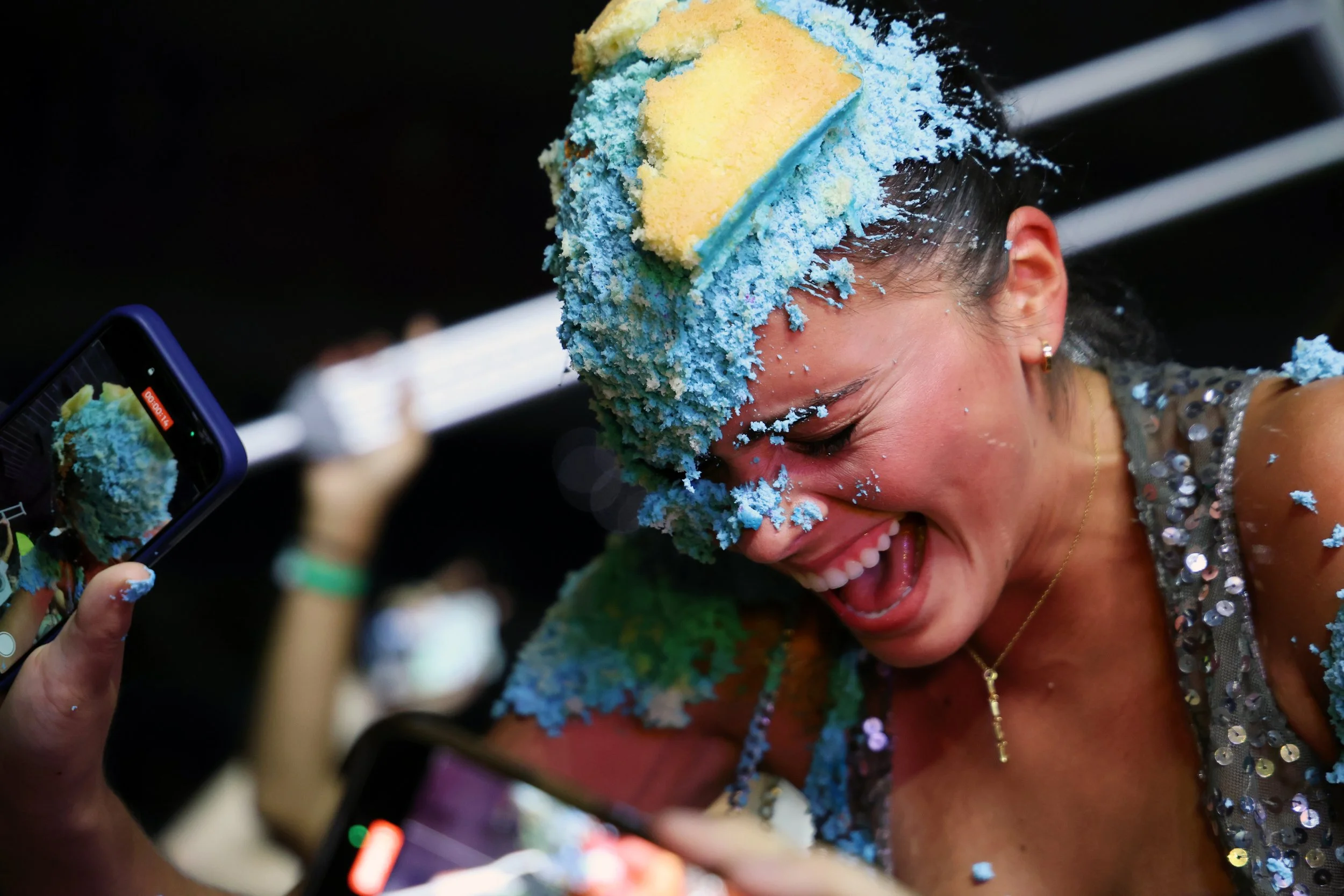 An attendee laughs after Steve Aoki threw a cake at her during the University of Florida’s Gator Growl at the O’Connell Center on Friday, Oct. 17, 2025.