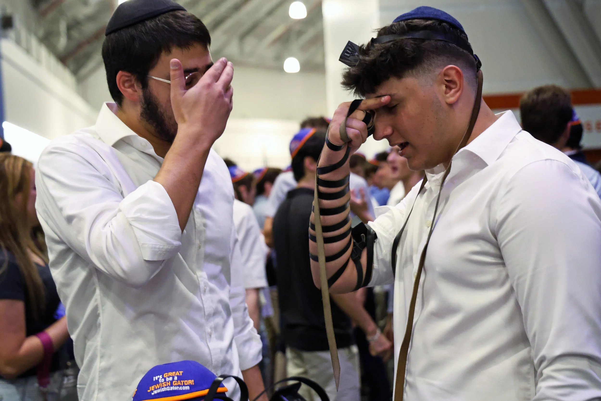 Mosche Weiss (left) prays with Rafael Kattan (right) after being wrapped in tefillin, traditionally worn by men during prayer, during UF Chabad’s Rosh Hashanah observance on Monday, Sept. 22, 2025. 