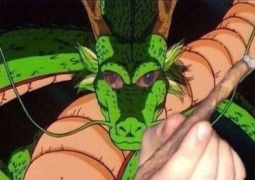 A drawing of a dragon with green and orange scales, with human hands holding an object, possibly a paintbrush, in the foreground.