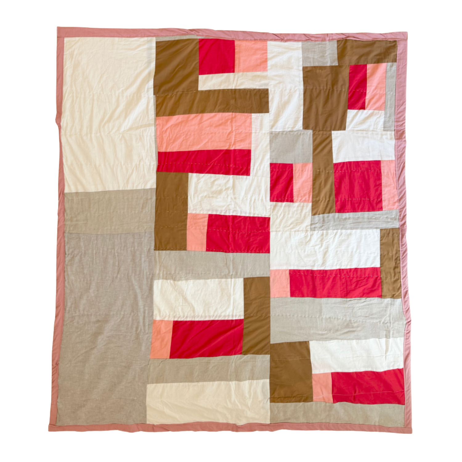 A patchwork quilt with a geometric pattern of red, pink, beige, tan, gray, and white fabric pieces, bordered by a pink edge.