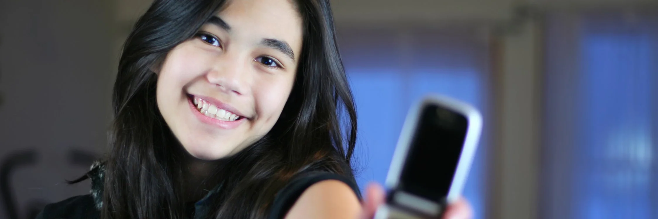 People shopping at a thrift store, browsing shelves filled with collectibles, toys, and decorative items.