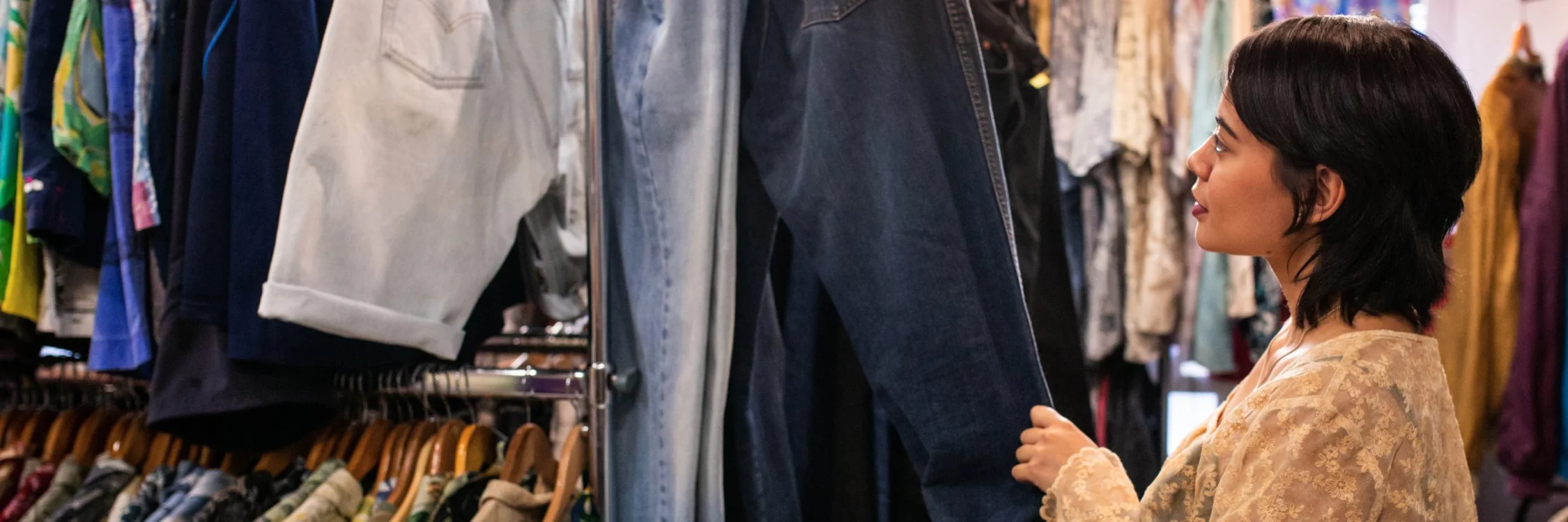 Close-up of red shopping carts in a thrift store, with one cart labeled 'ACTS THRIFT STORE' in white text.
