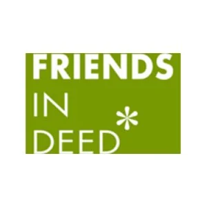 A smiling woman with long black hair, showing her teeth, wearing a white top and a necklace.