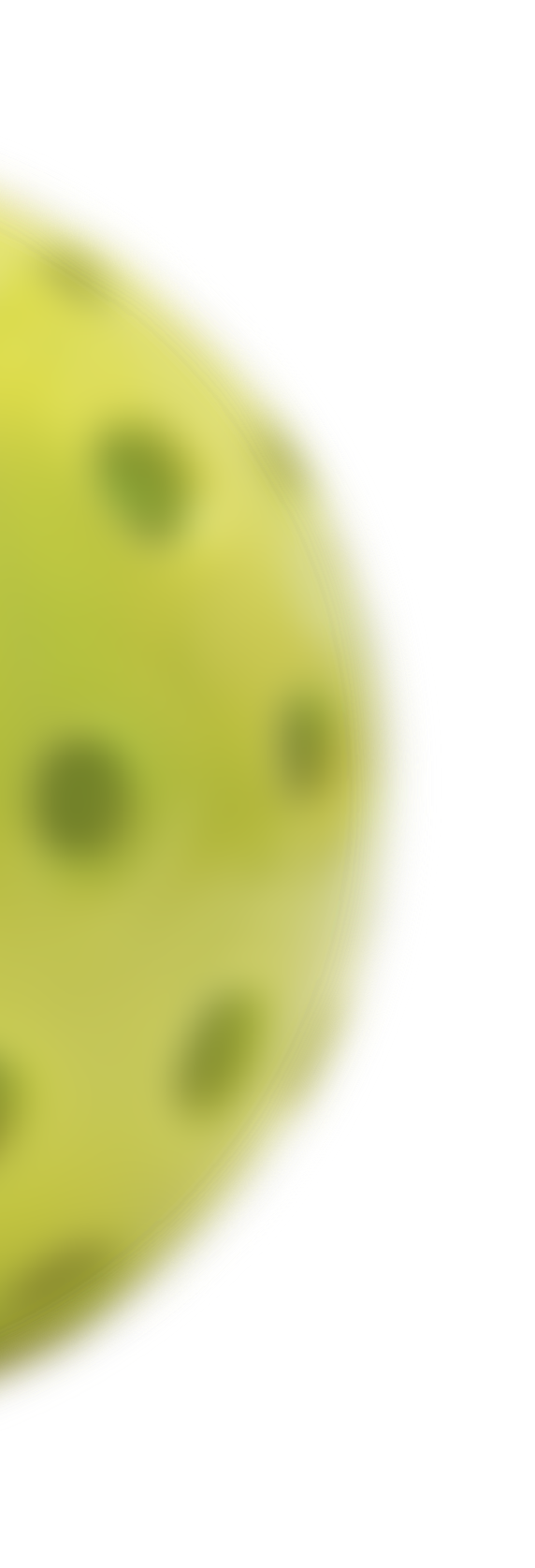 Close-up of a yellow tennis ball with a blurred green tennis court in the background.