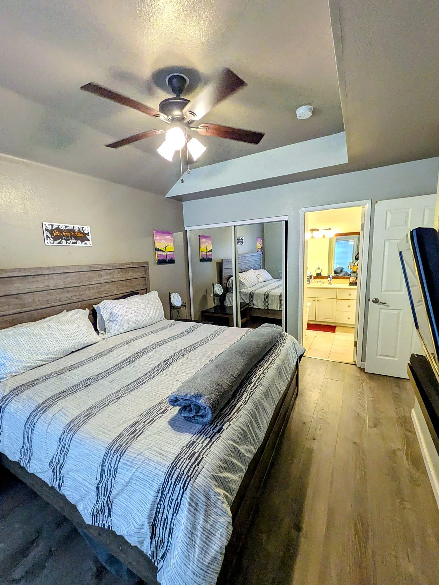Sliding doors and a mirrored closet run.