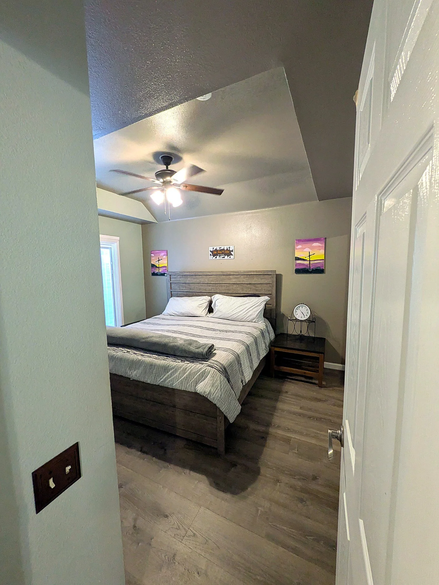 Primary bedroom with a ceiling fan and good natural light.