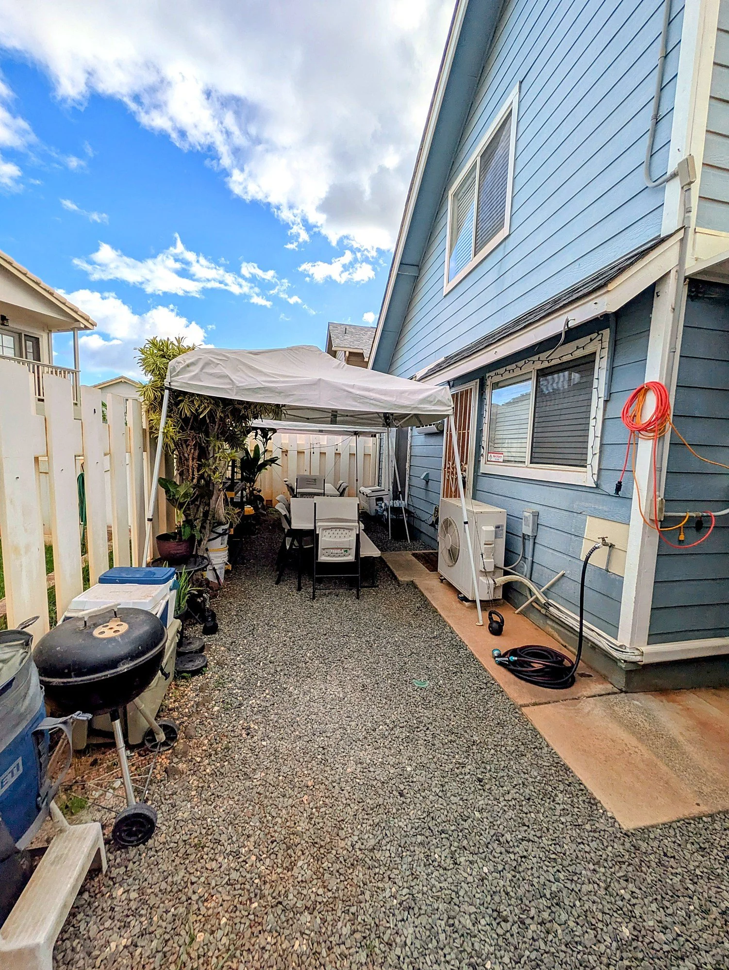 Side yard with room to grill, work, or park the toys.