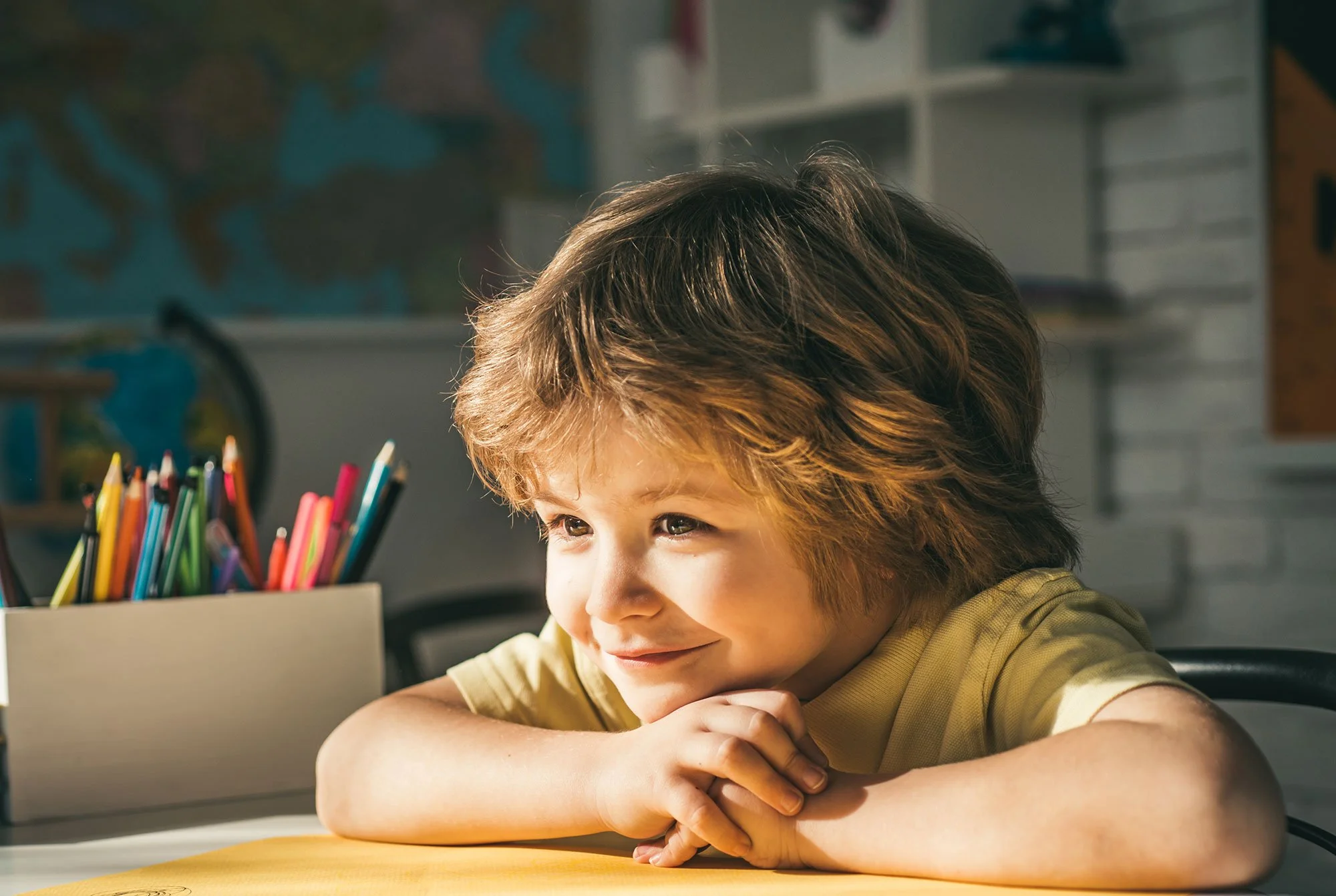 Young Smiling Boy at desk