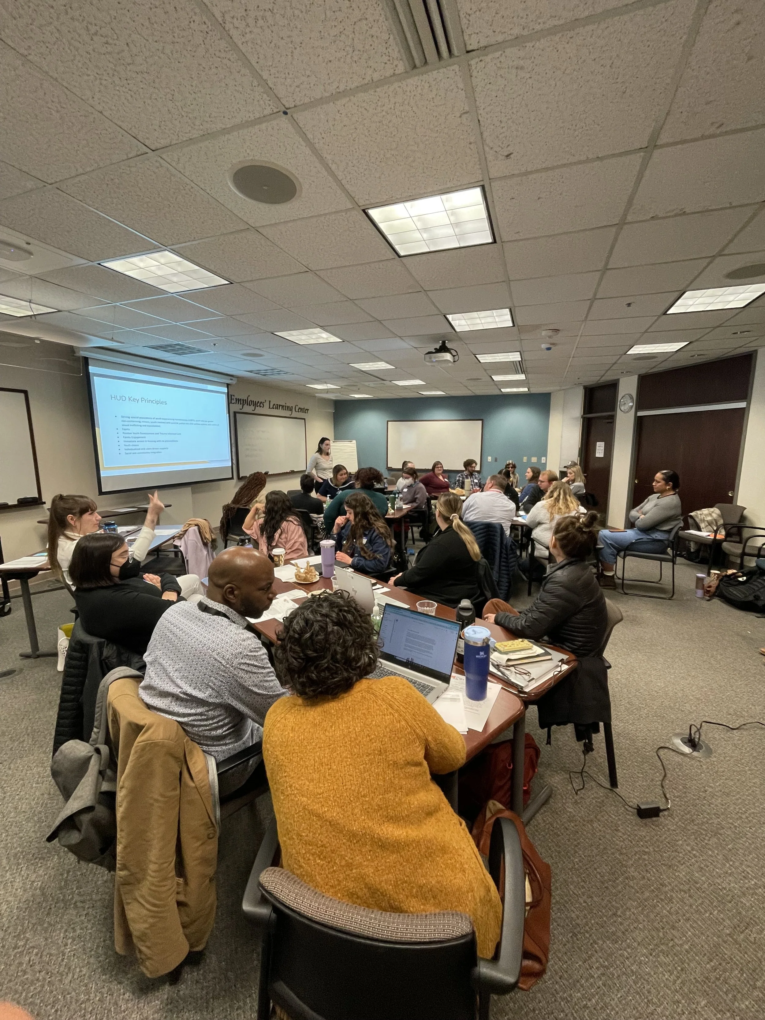 A diverse group of employees attending a mental health training and workshop.