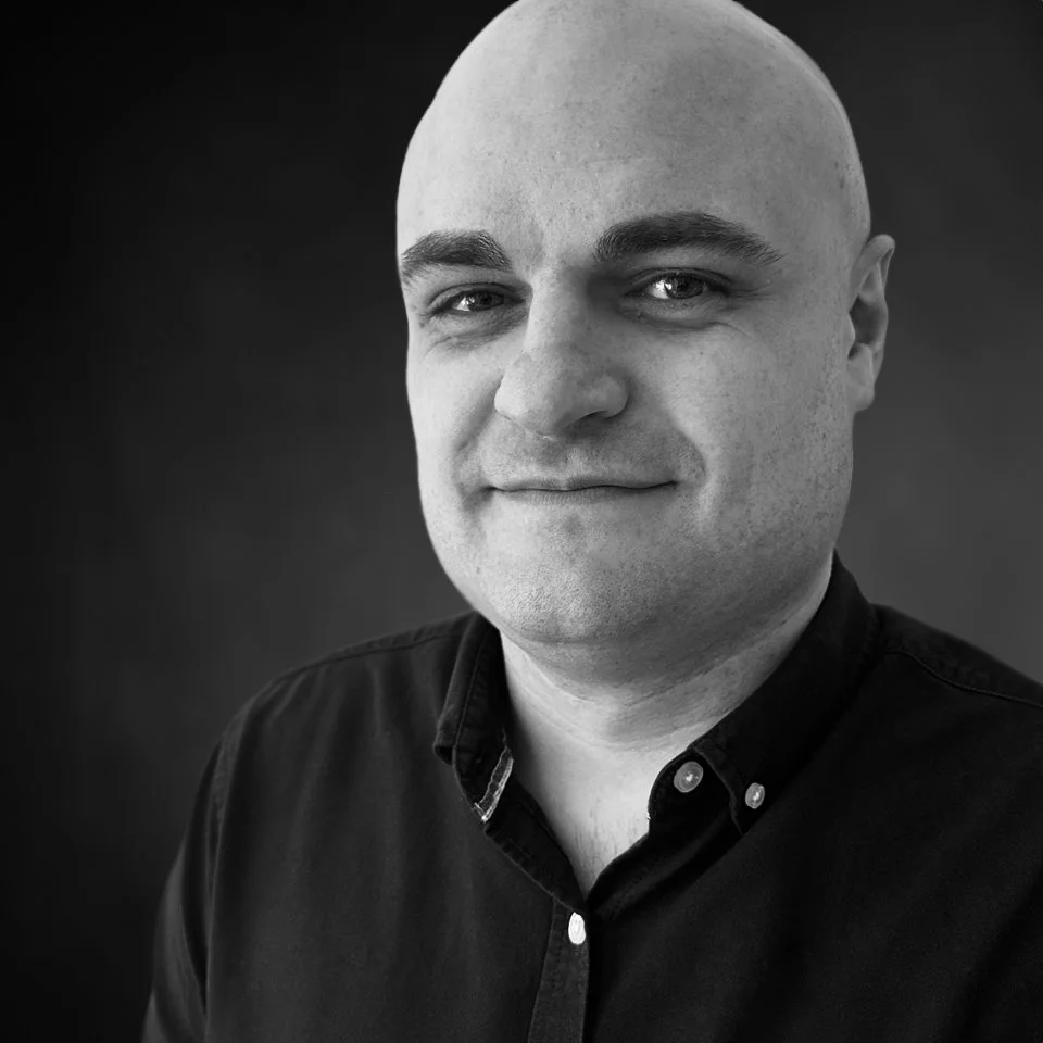 Black-and-white portrait of Stephen Miller, COO.