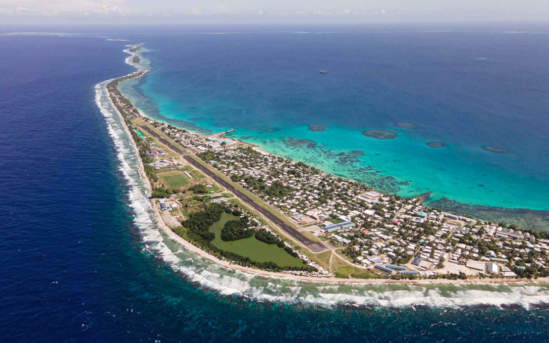 Aerial view of the Funafuti airstrip in Tuvalu, a narrow coral atoll where traditional sap-based bread baking thrives despite the lack of wheat fields.