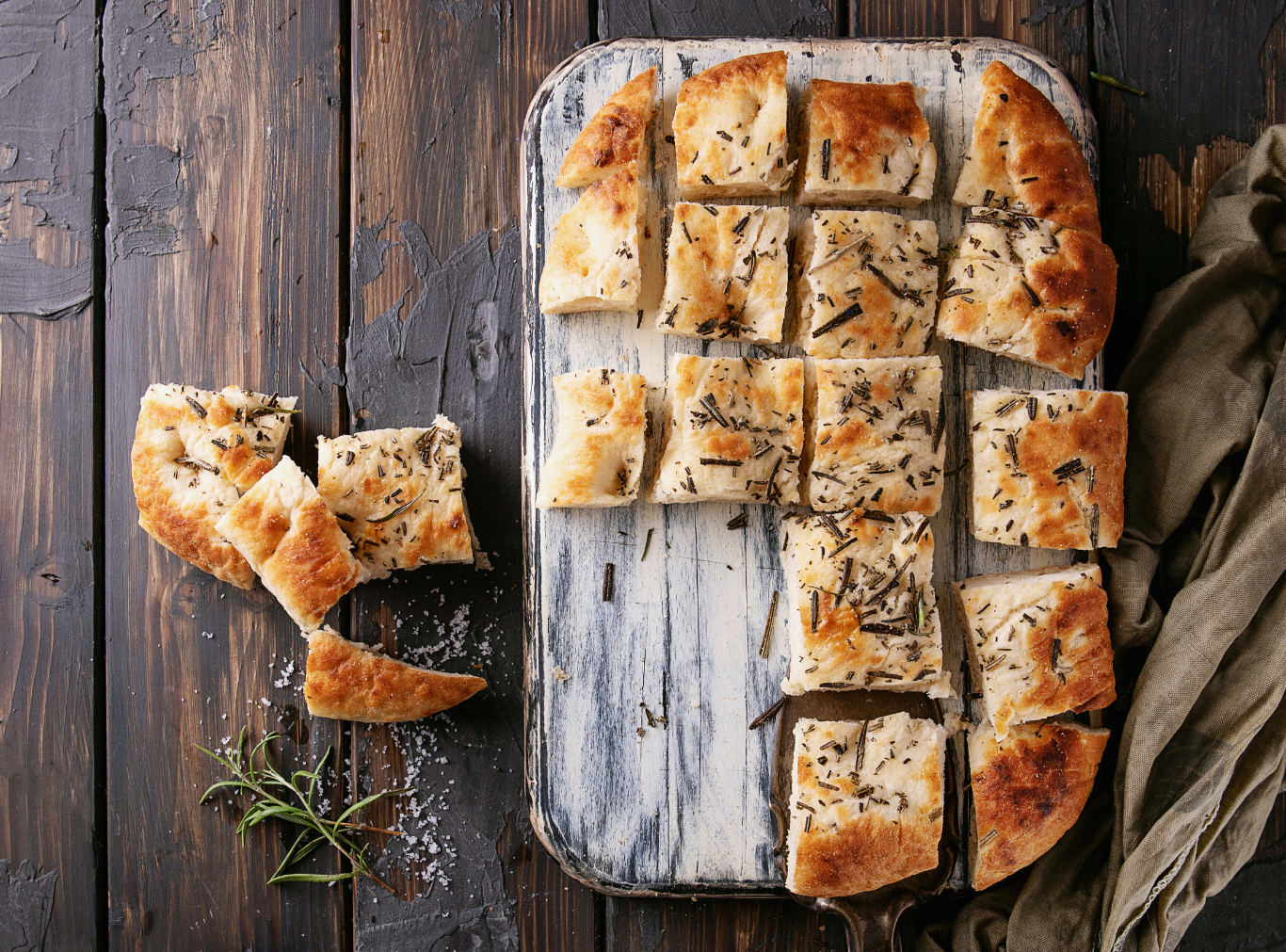 Top-down view of the Ultimate Airy Focaccia, showing deep finger-dimples filled with golden olive oil and pockets of flaky sea salt.