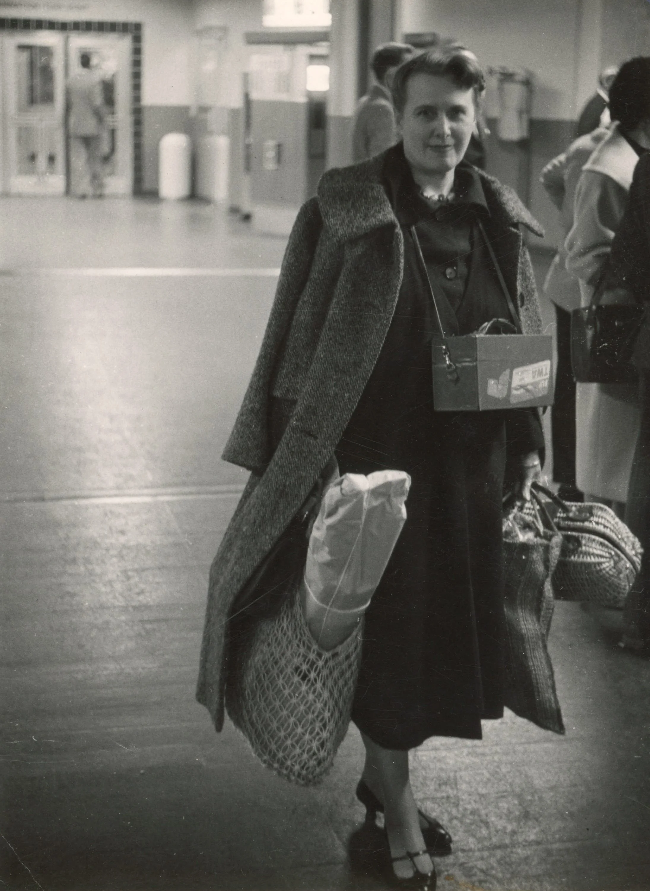 Claire Falkenstein at a train station, possibly Rome, Italy, c. 1954