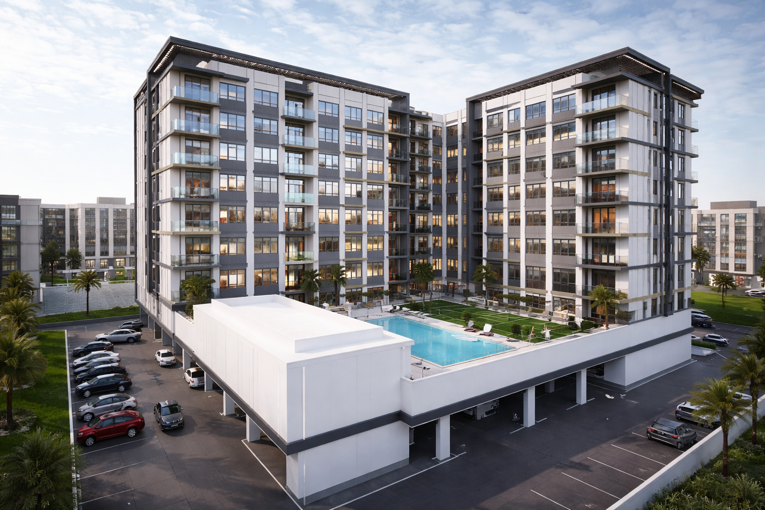 Modern multi-story apartment building with a swimming pool in the courtyard, surrounded by parking spaces and palm trees.