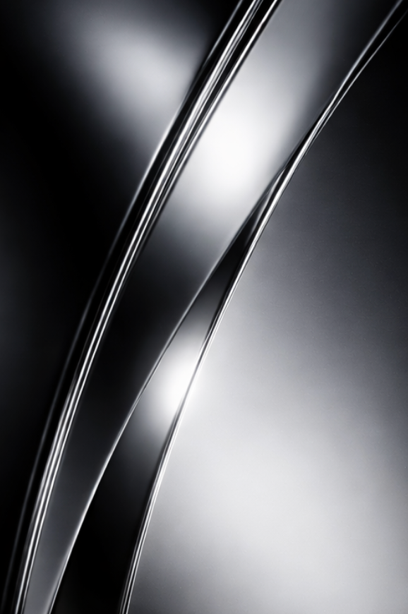 Close-up of reflective metal surface with curved lines and smooth texture.