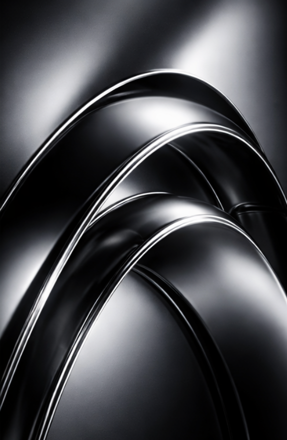Close-up of multiple black metallic curved objects with shiny edges.