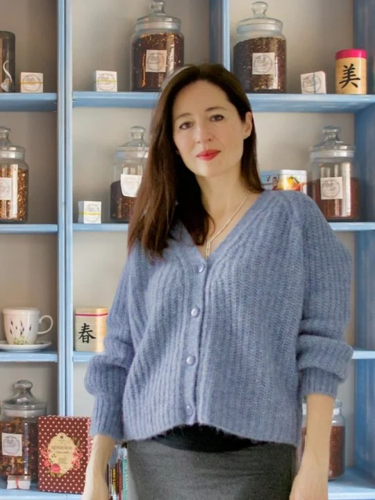 Marina Danilova standing in front of the shelves with herbal medicine