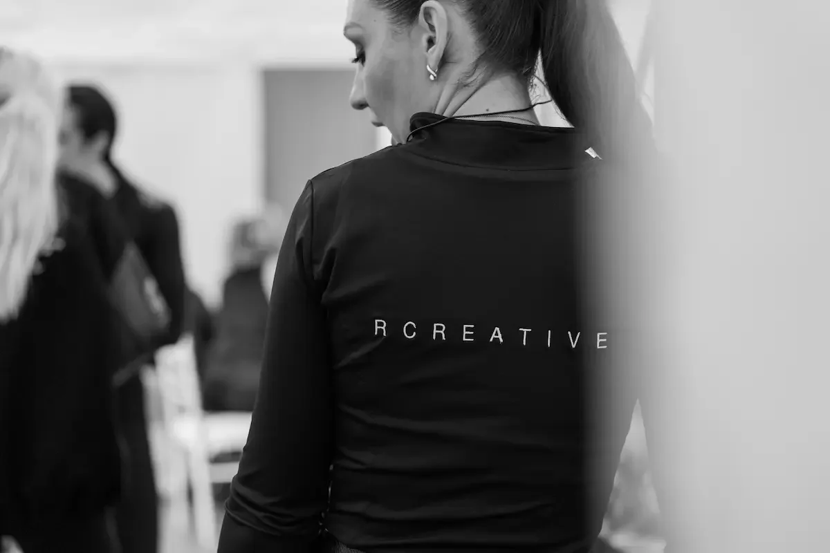 Team member wearing an RCREATIVE branded jacket during event setup