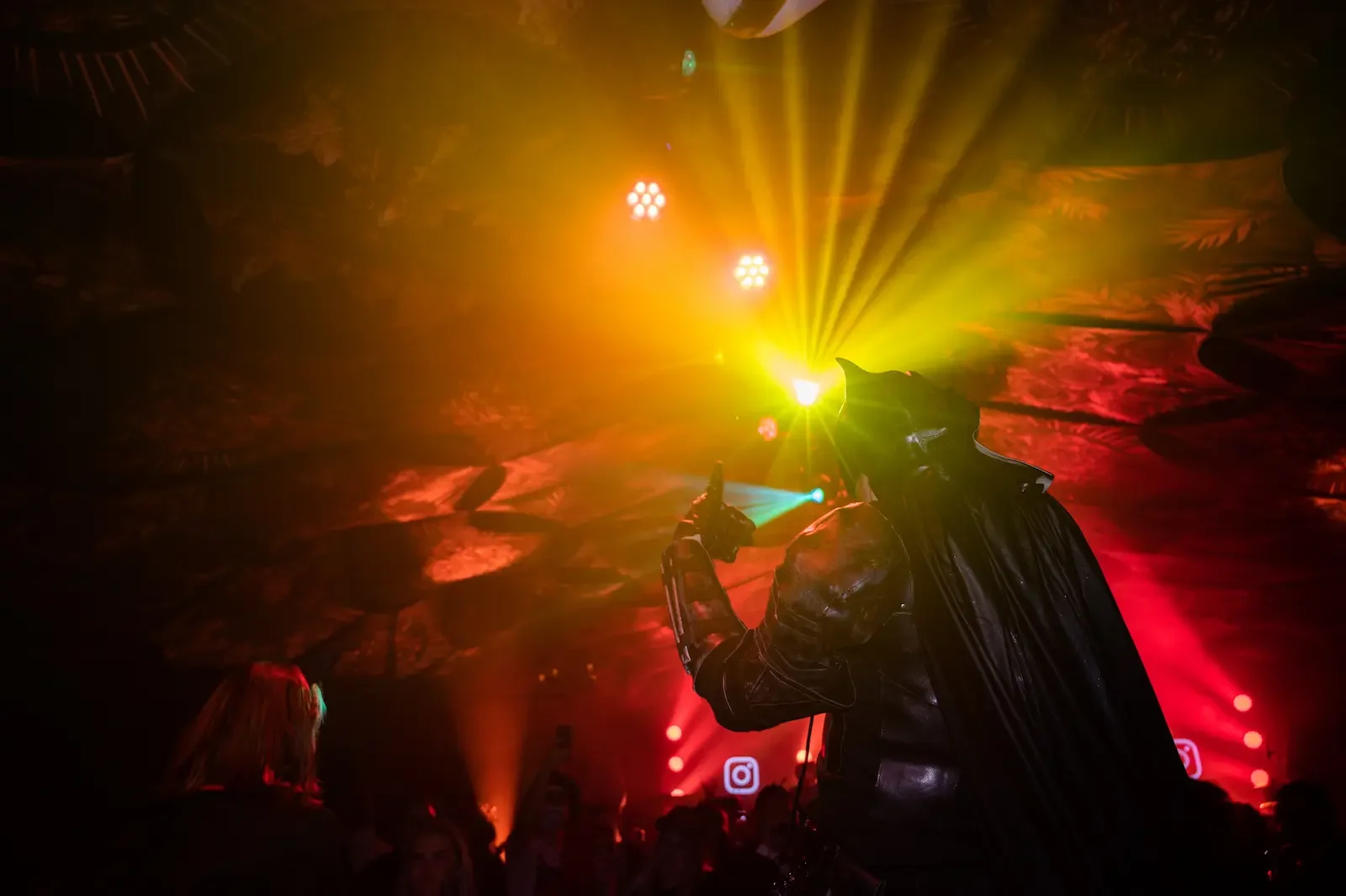 Batman costumed performer DJing during an immersive experience