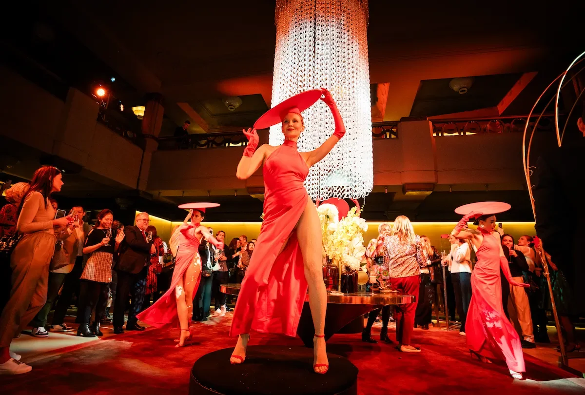 Dancer in red dress captivating crowd at exclusive hotel event