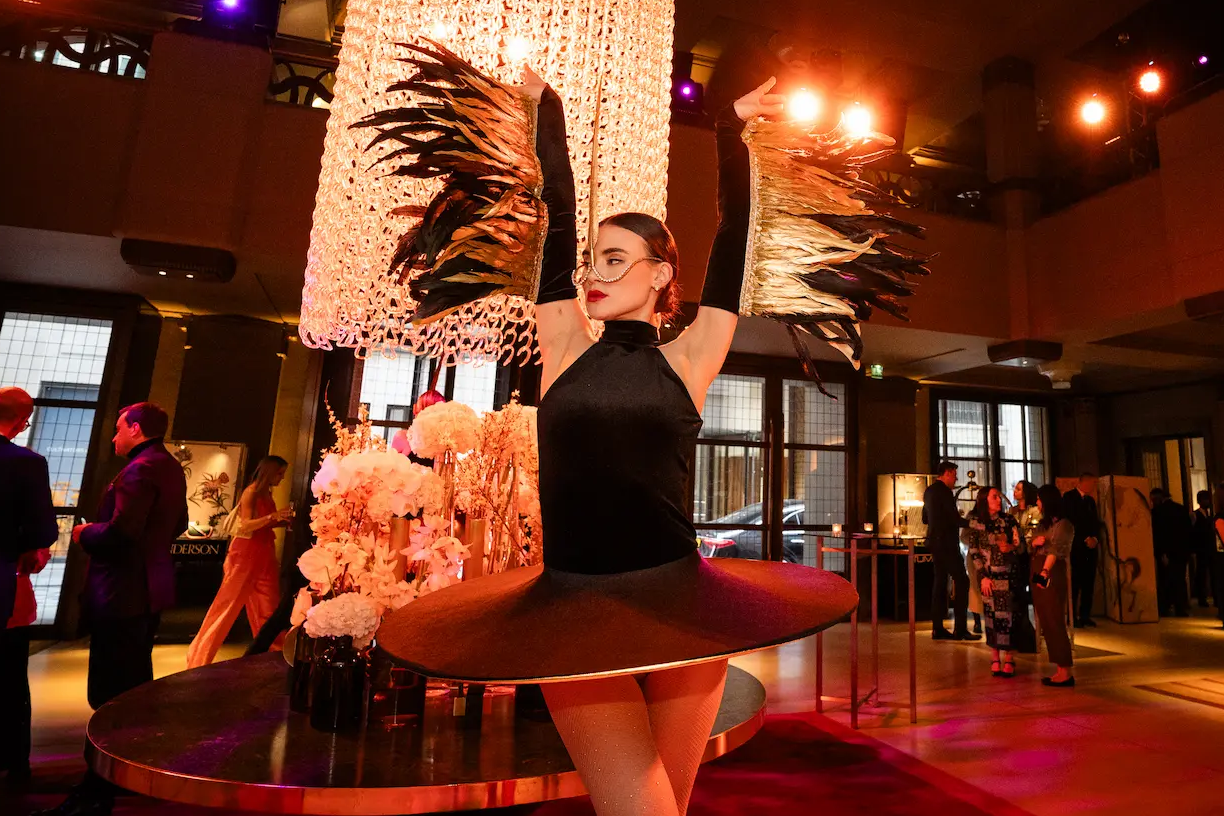 Feathered ballerina dancing in an industry party at Hotel Café Royal.