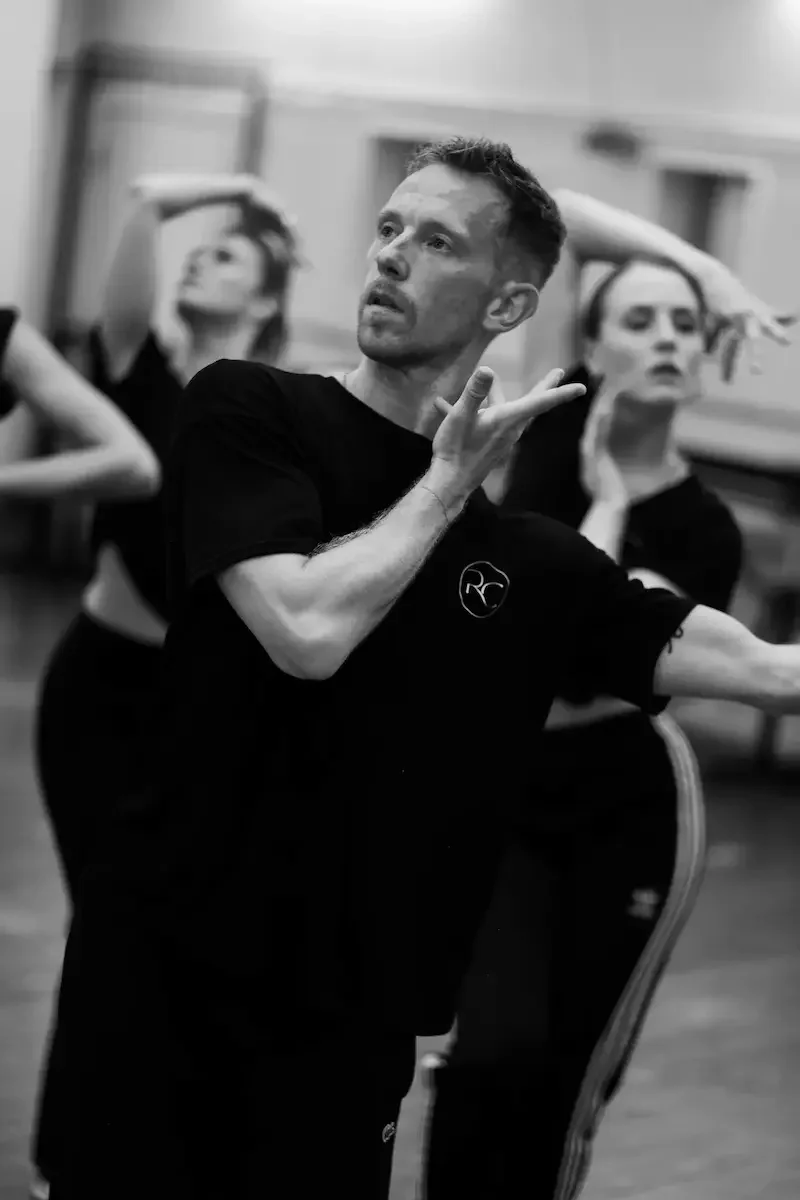 Dance instructor teaching ballroom techniques in professional studio