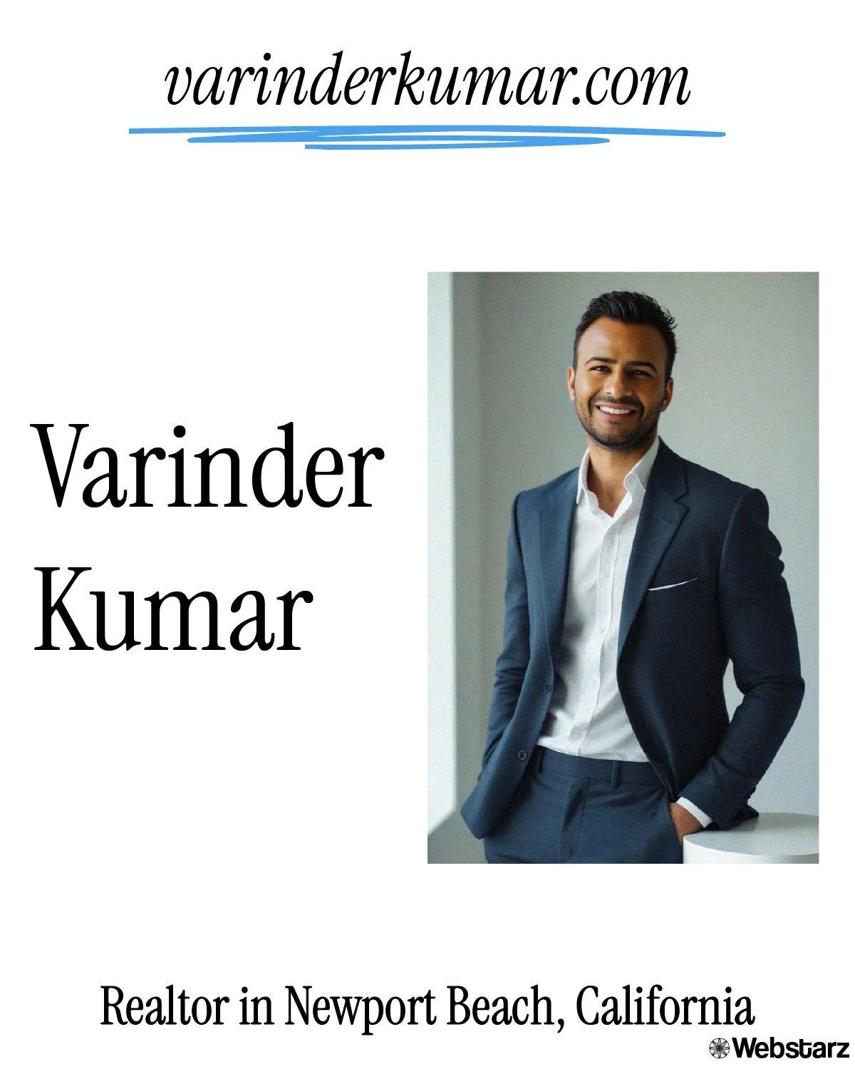 Professional portrait of a man in a navy suit, white shirt, smiling, standing indoors with a neutral background.