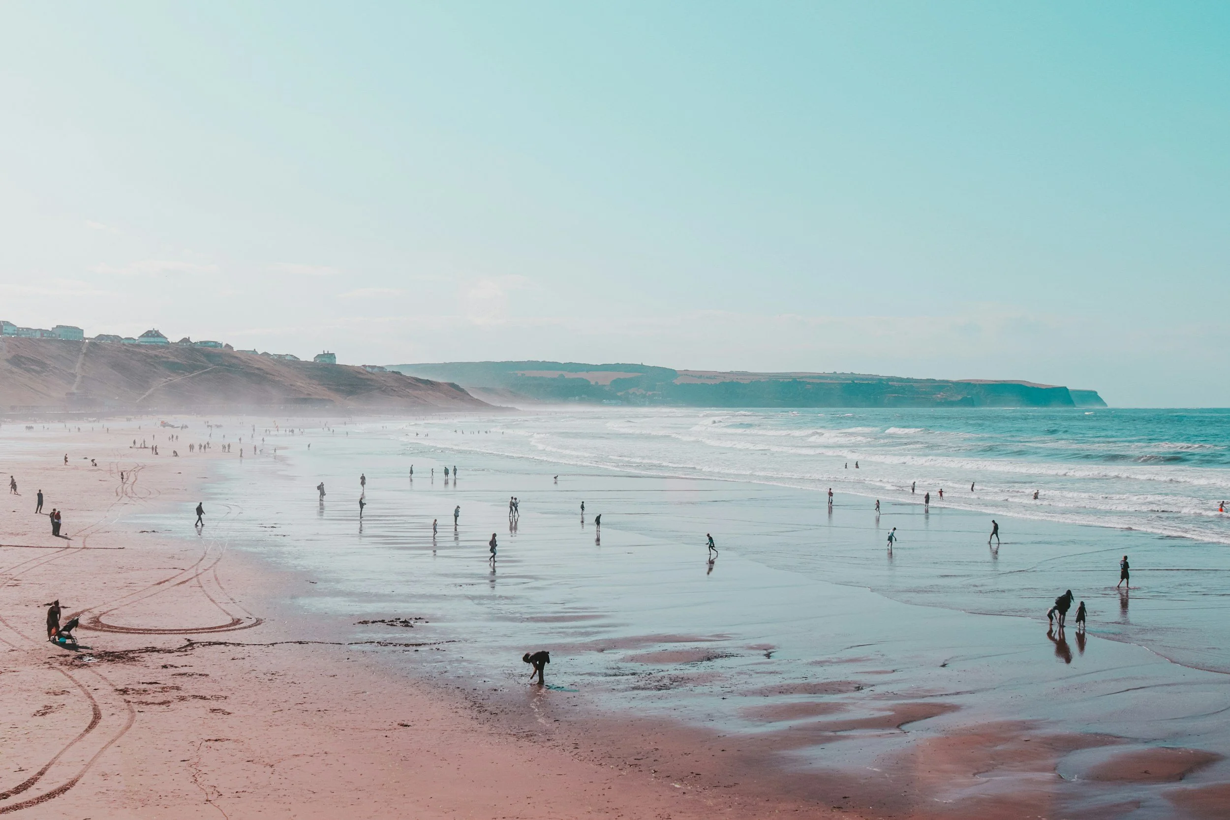 cornish beach scene with people padding