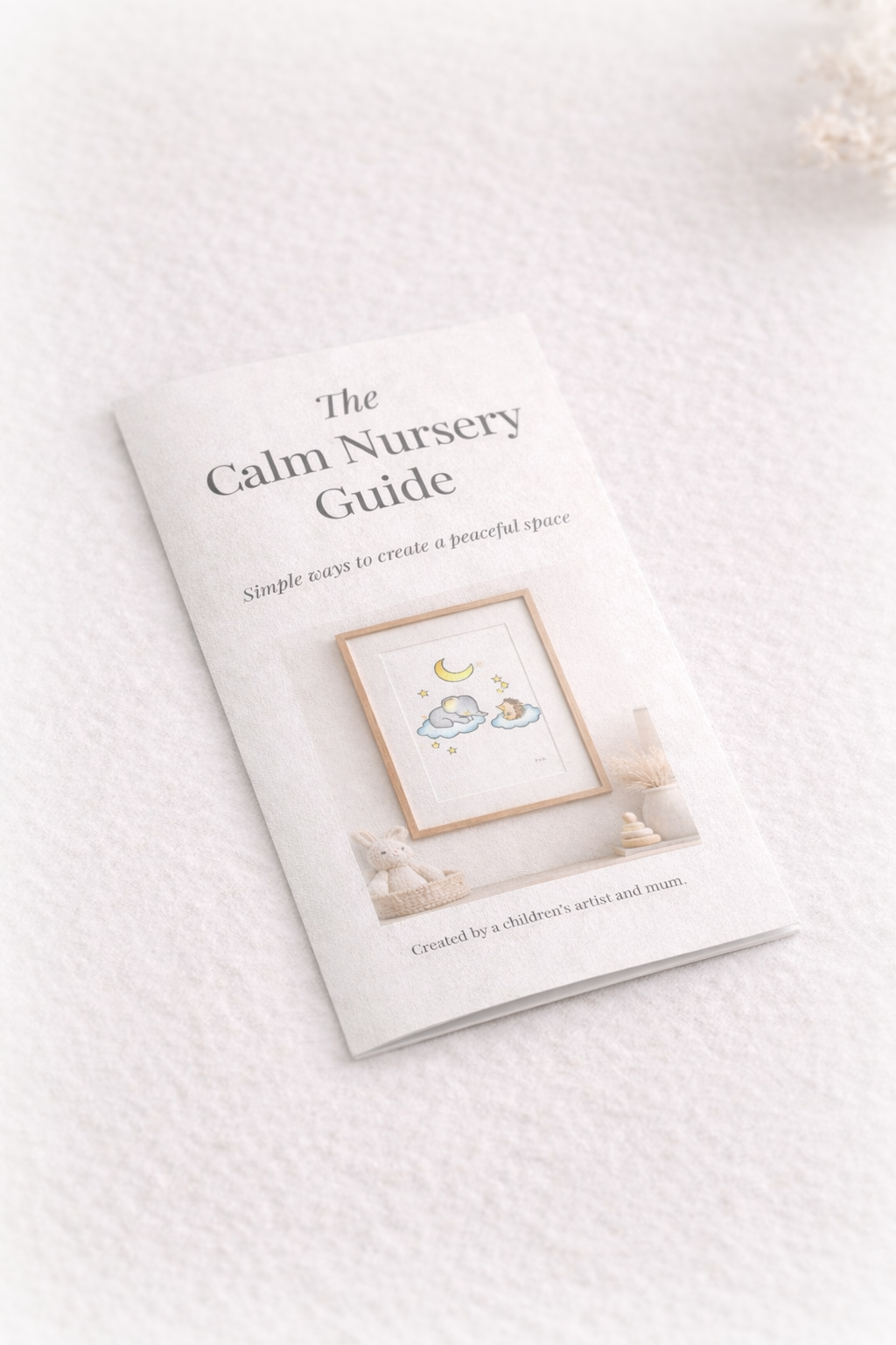 Printed calm nursery guide pamphlet lying flat, featuring neutral tones and gentle nursery artwork