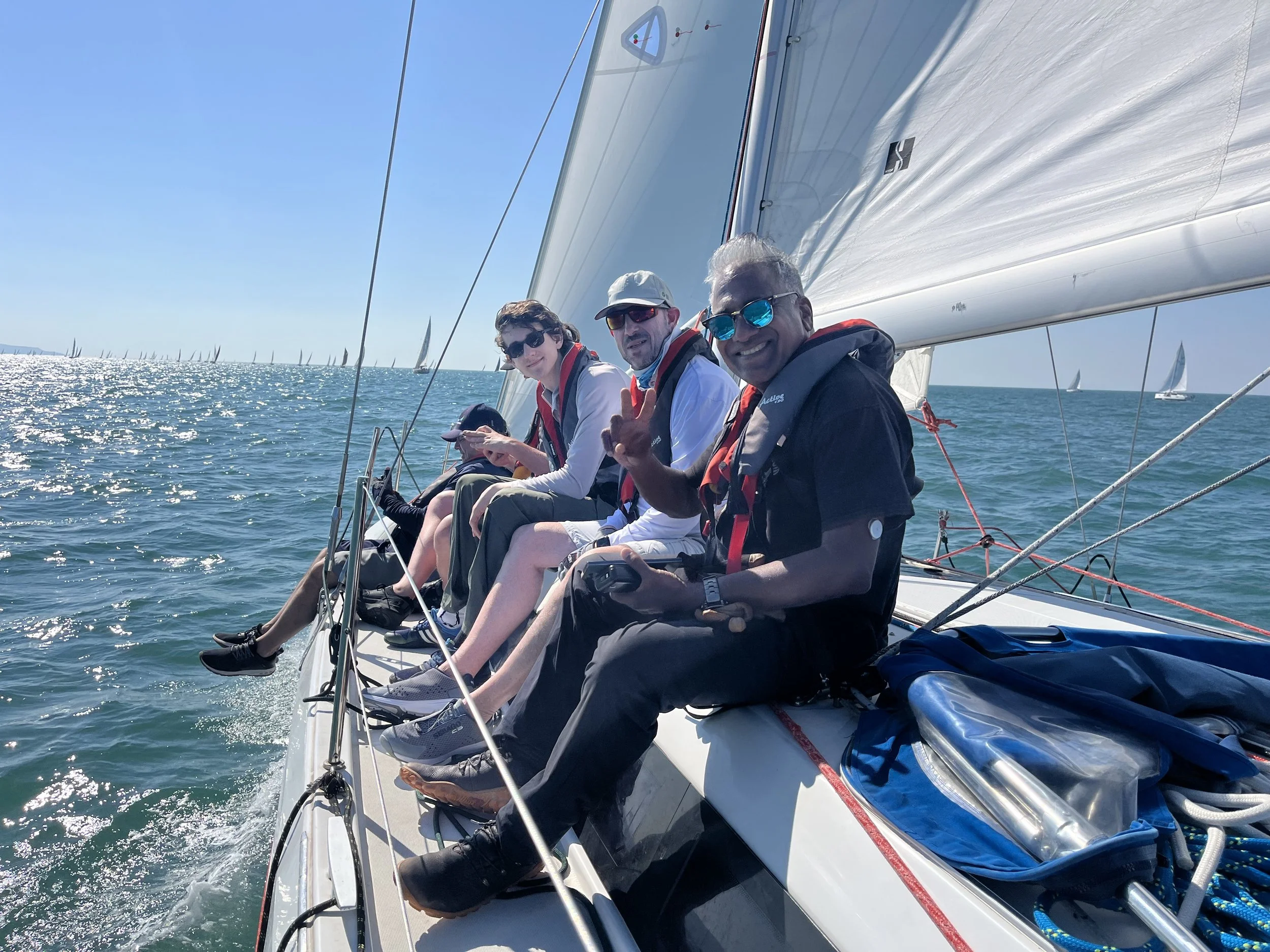Crew sailing together in sunshine