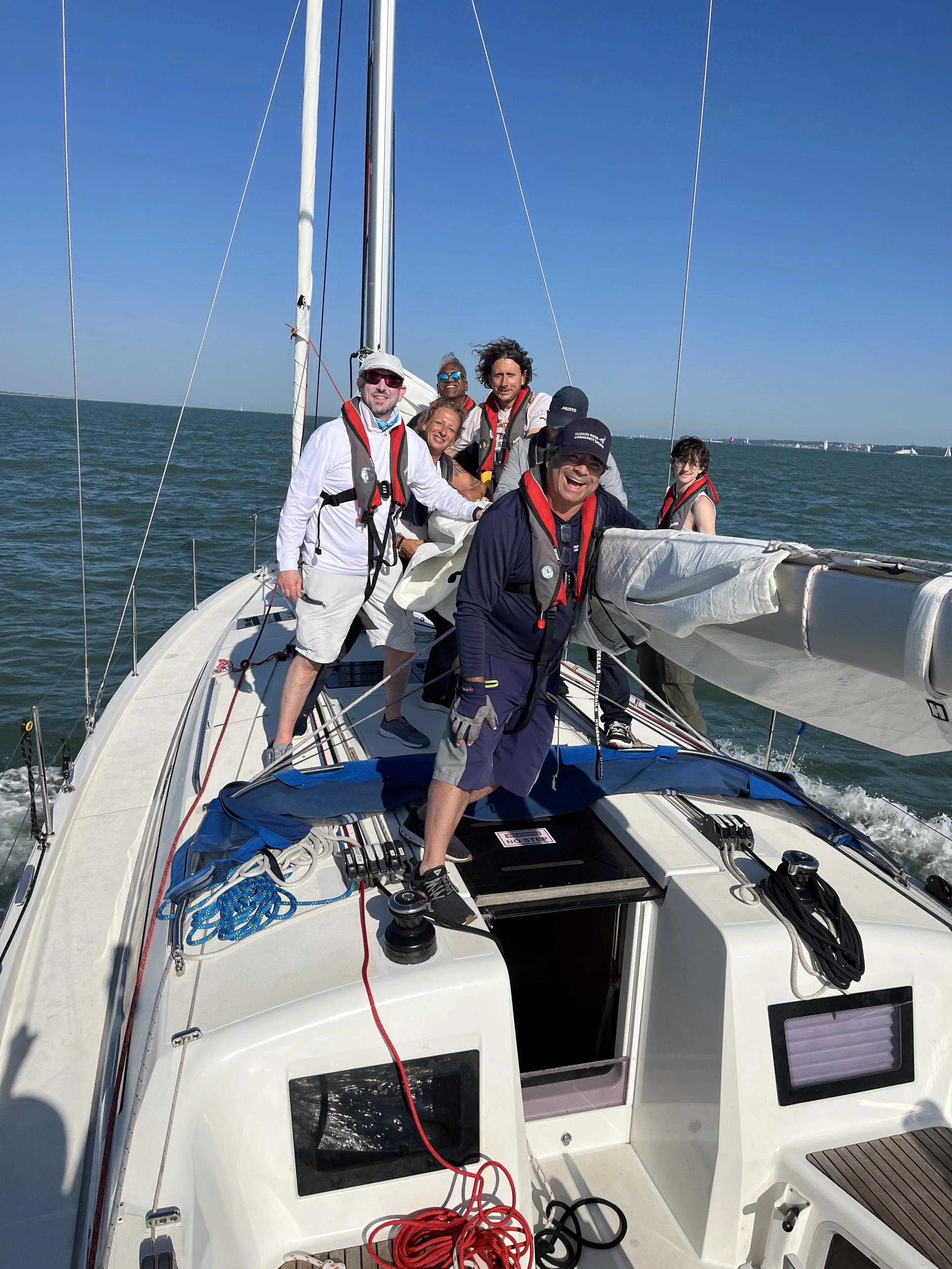 Crew together on deck in sunshine