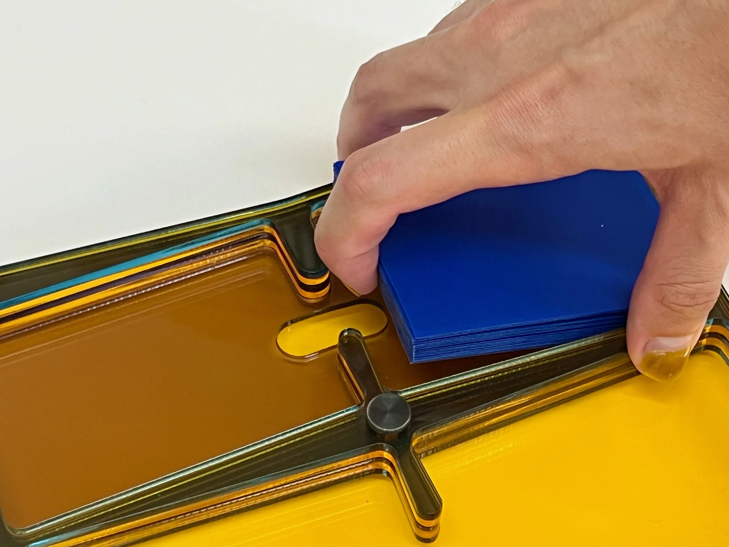 With the lifter cutout a finger can easily get purchase under the card stack and lift