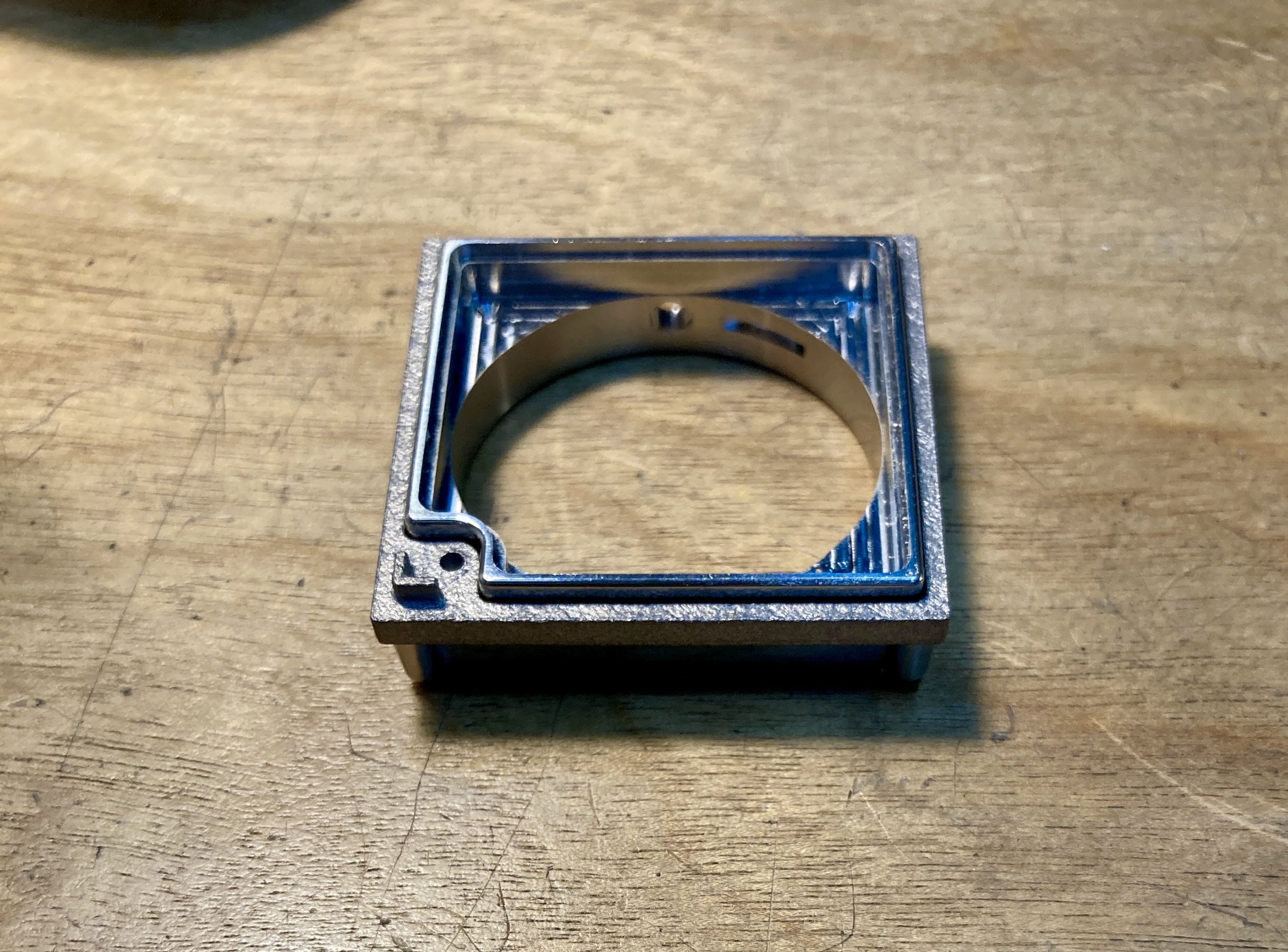 Integration of printed bezel and machined core designed to minimize tolerance stack
