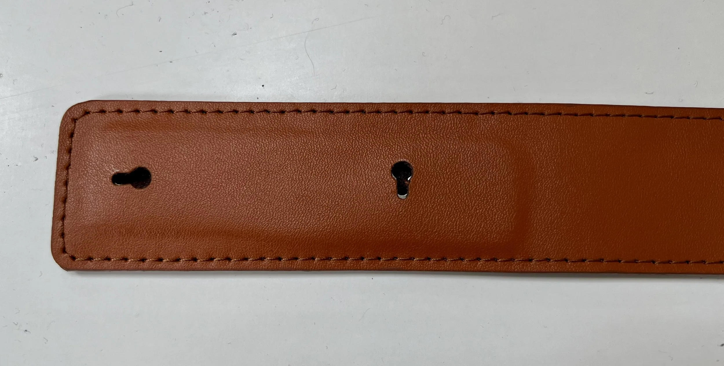 Keyhole mounts shown integrated in leather