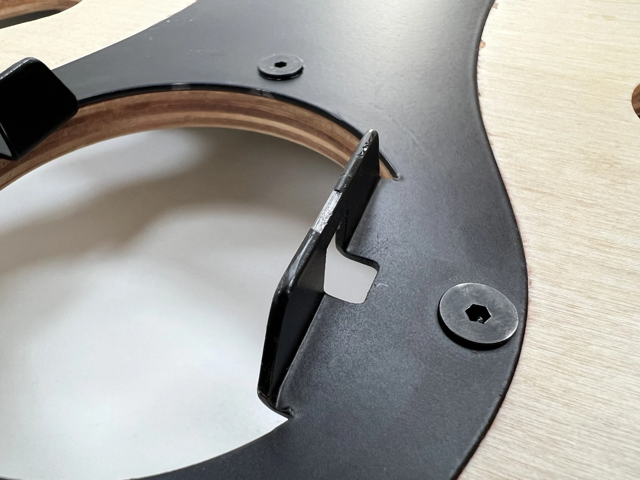 Sheet metal locking teeth under inspection - powder coat durability was critical to reliable engagement