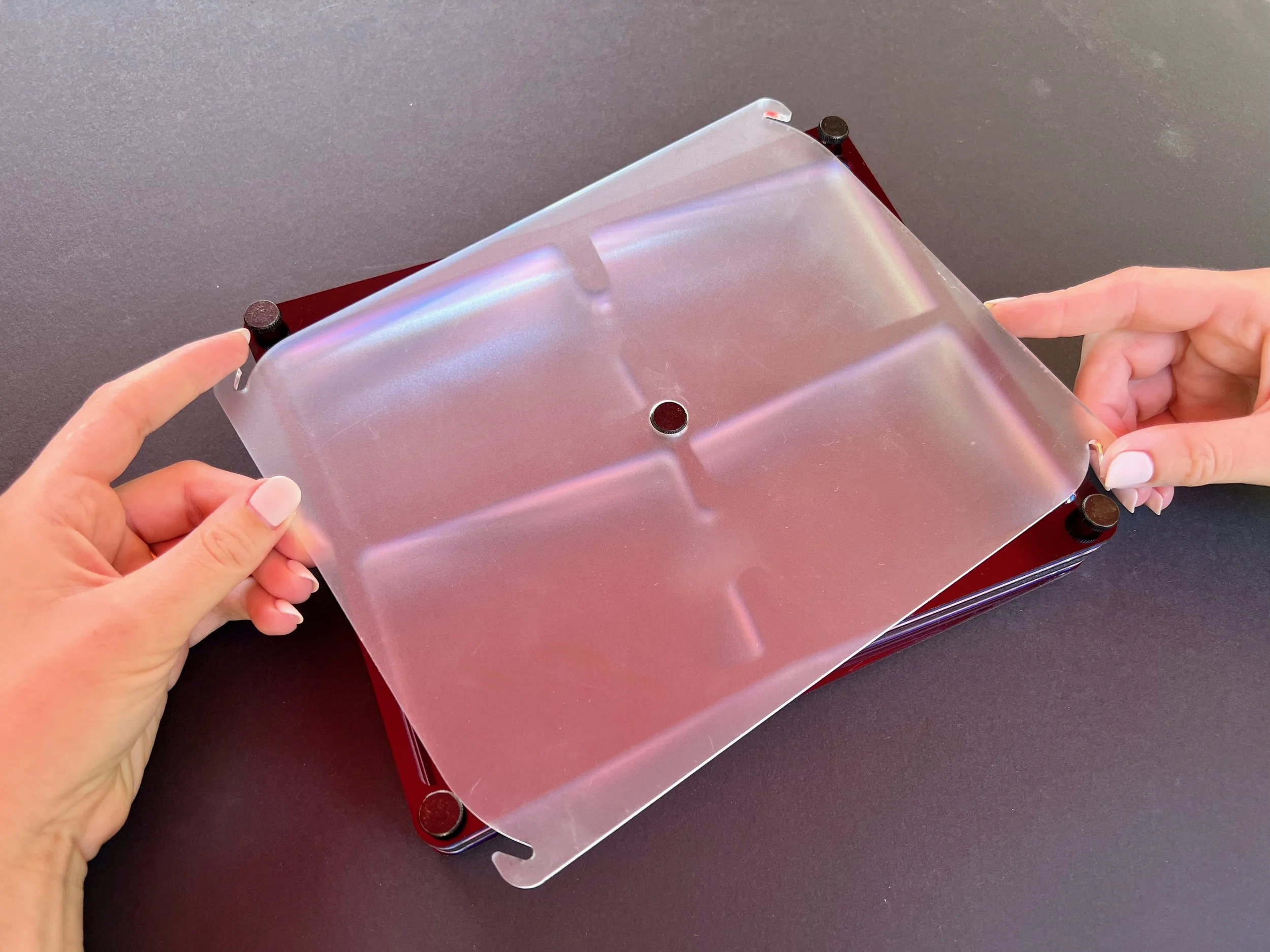 The final design has four corner thumb screws that, when turned a small amount, allow the lid to twist clear and be removed