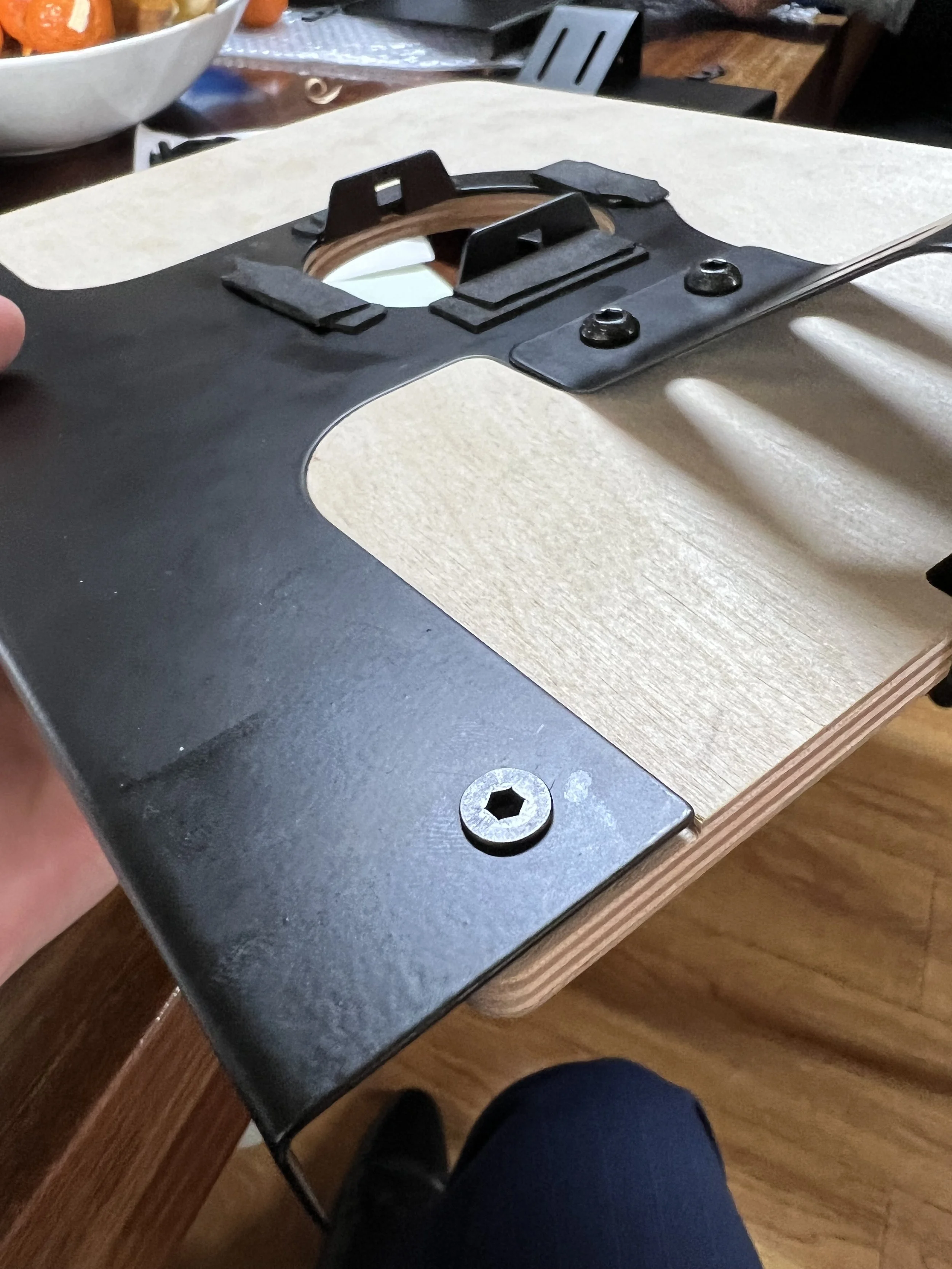 Precision-machined metal inlay seated flush into Baltic birch - prototype stage